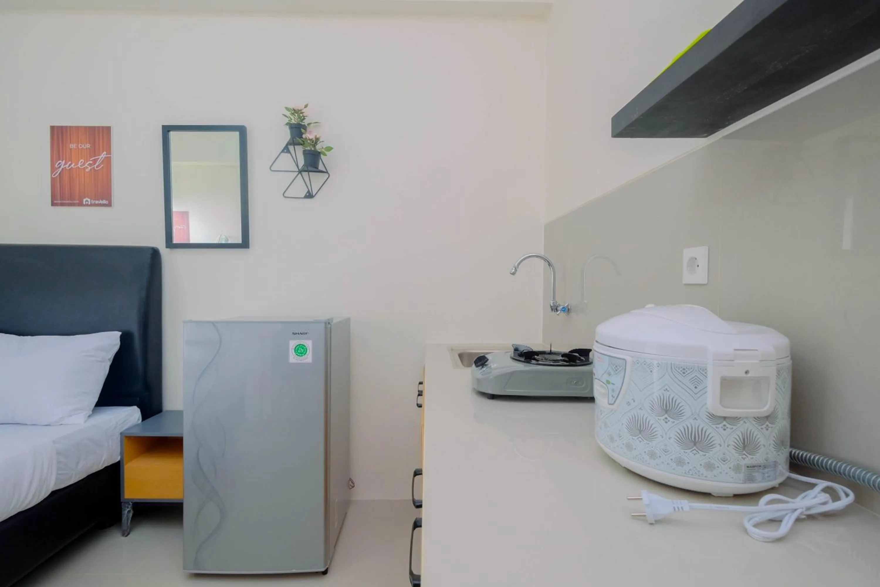 Kitchen or kitchenette, Bed in Comfy Studio Bogorienze Apartment near The Jungle Fest By Travelio