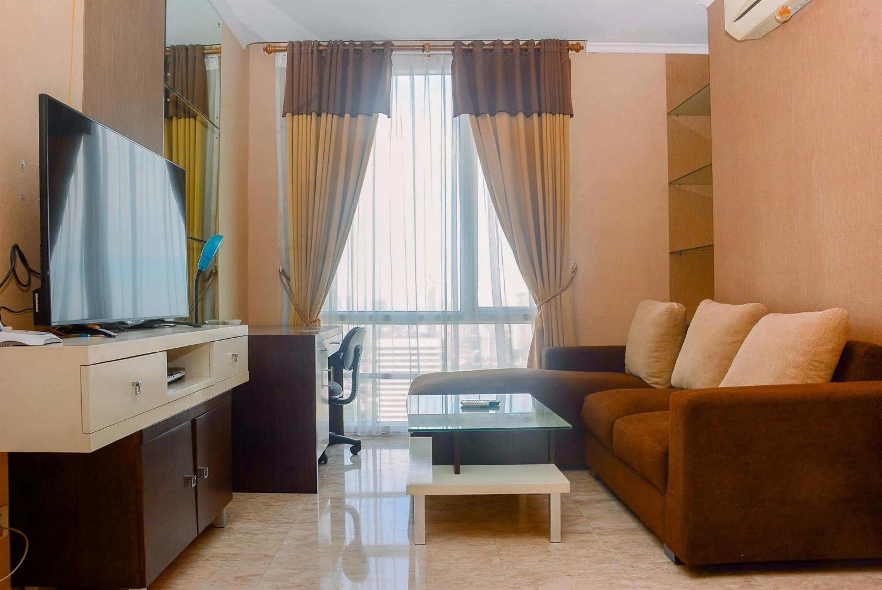 Living room in Strategic Location 2BR Apartment at FX Residence By Travelio