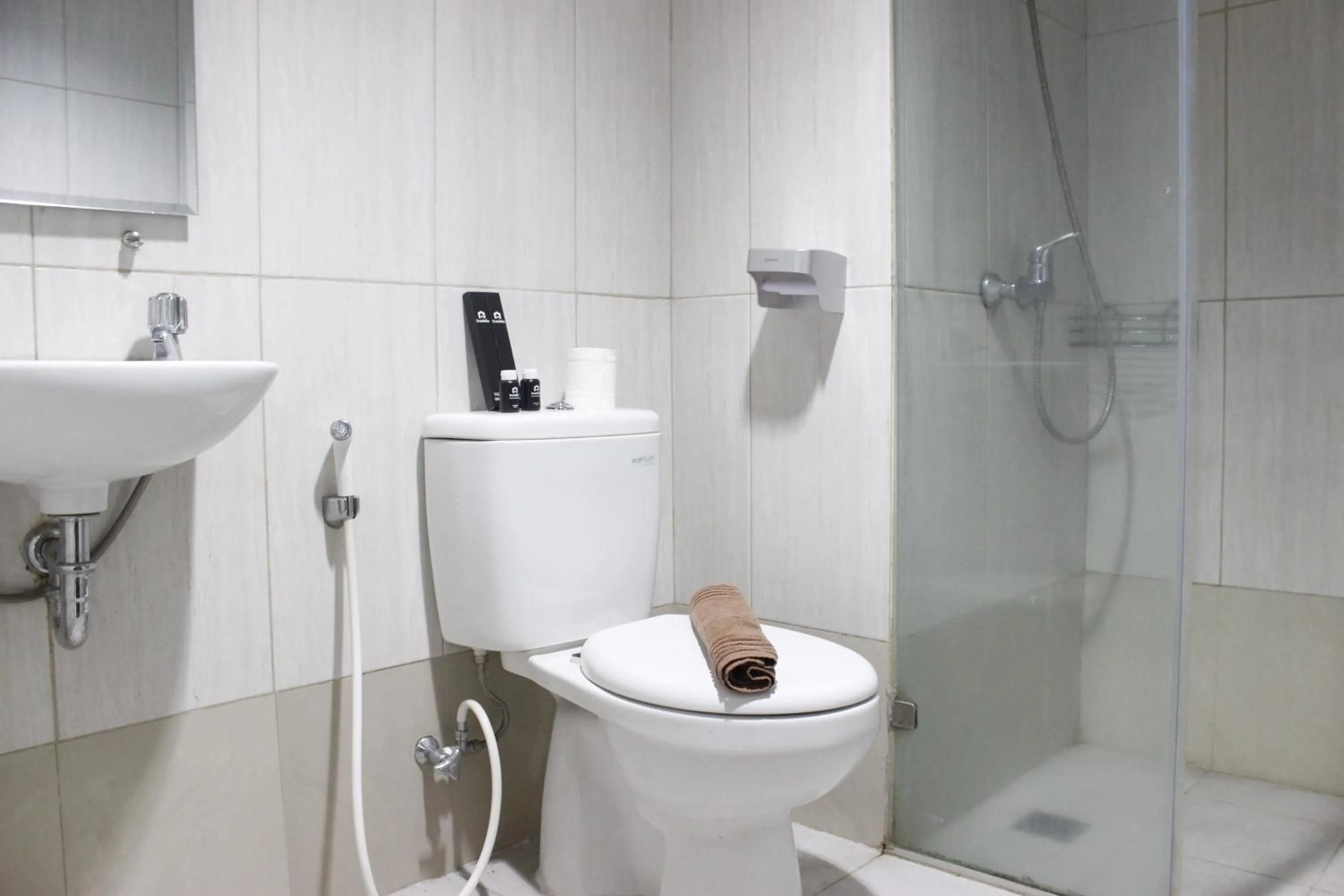 Bathroom in Prime and Comfy Studio at Tamansari La Grande Apartment By Travelio