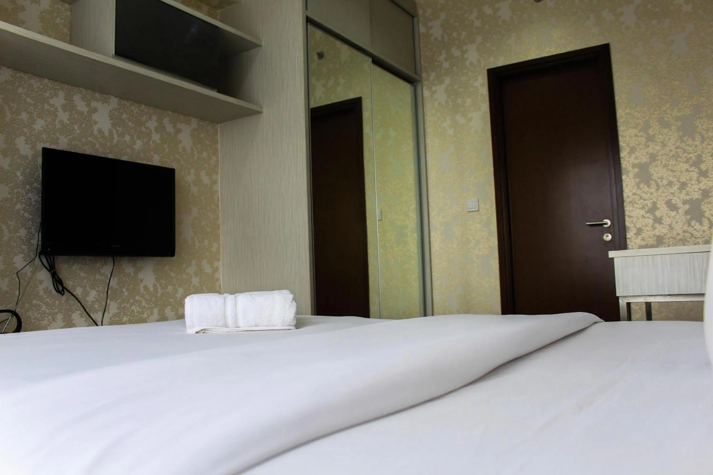 Bed in Minimalist 1BR Apartment at M-Town Signature By Travelio