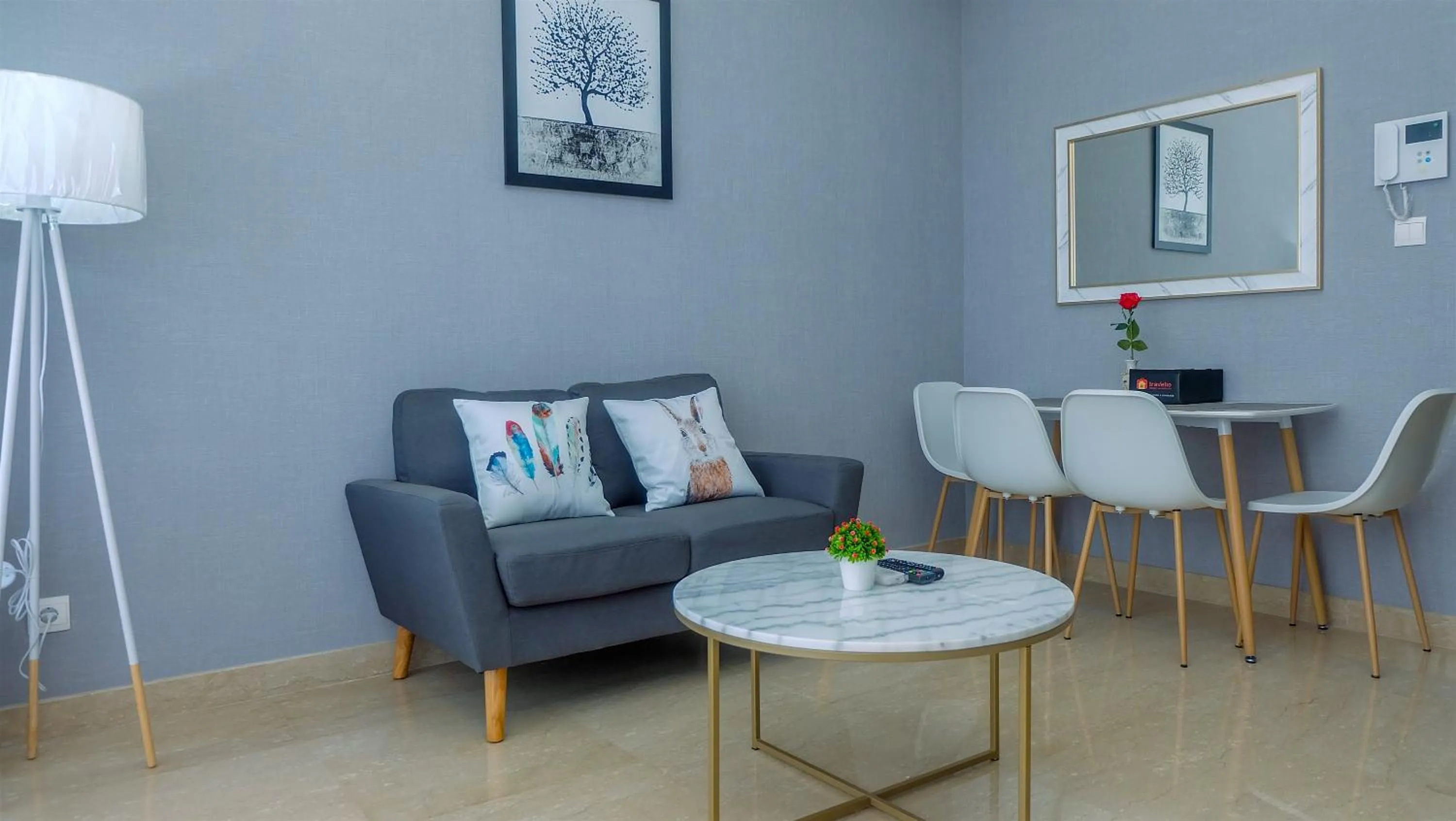 Living room in Classy 2BR Apartment at Menteng Park with City View By Travelio