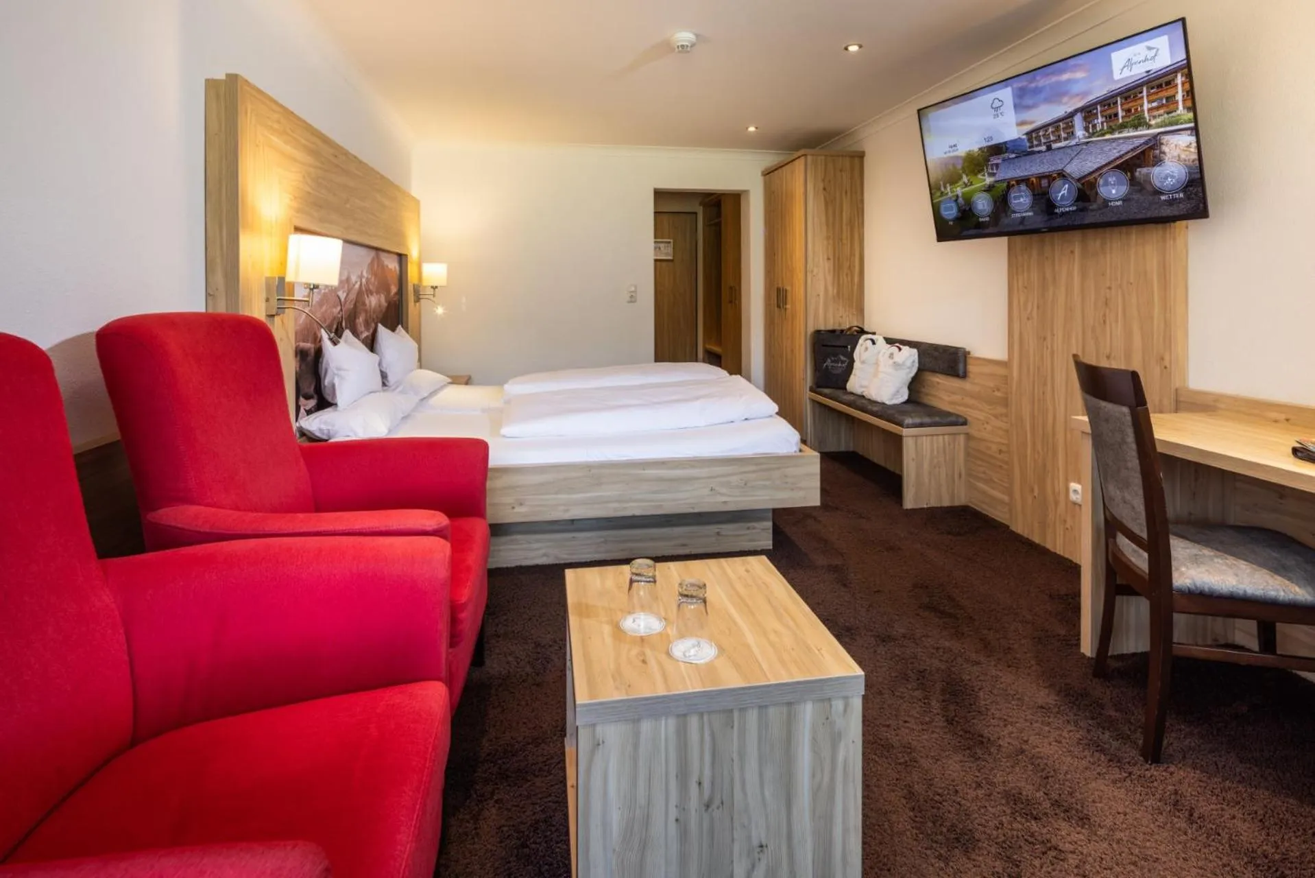 Living room, Bed in Alm- & Wellnesshotel Alpenhof