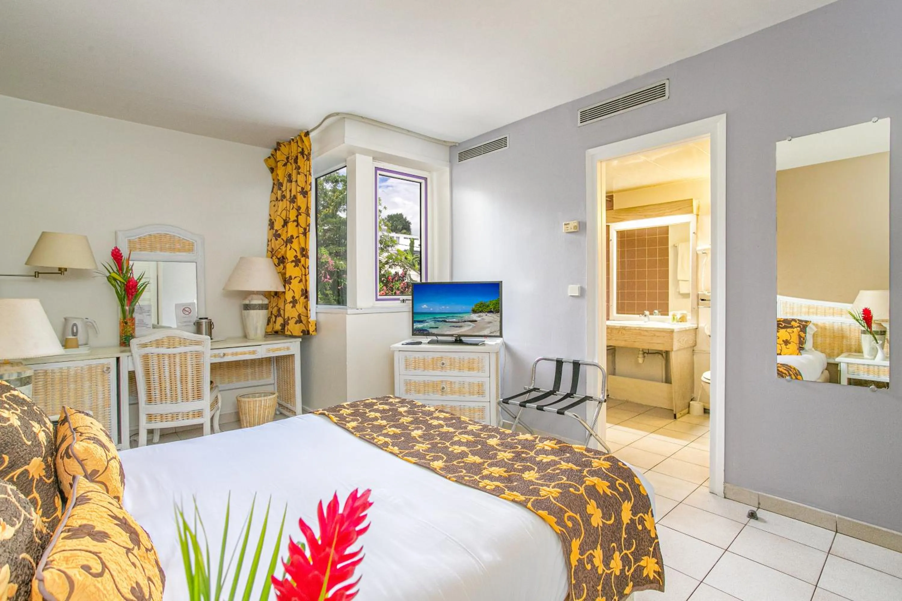 Bed in Karibea Squash Hôtel