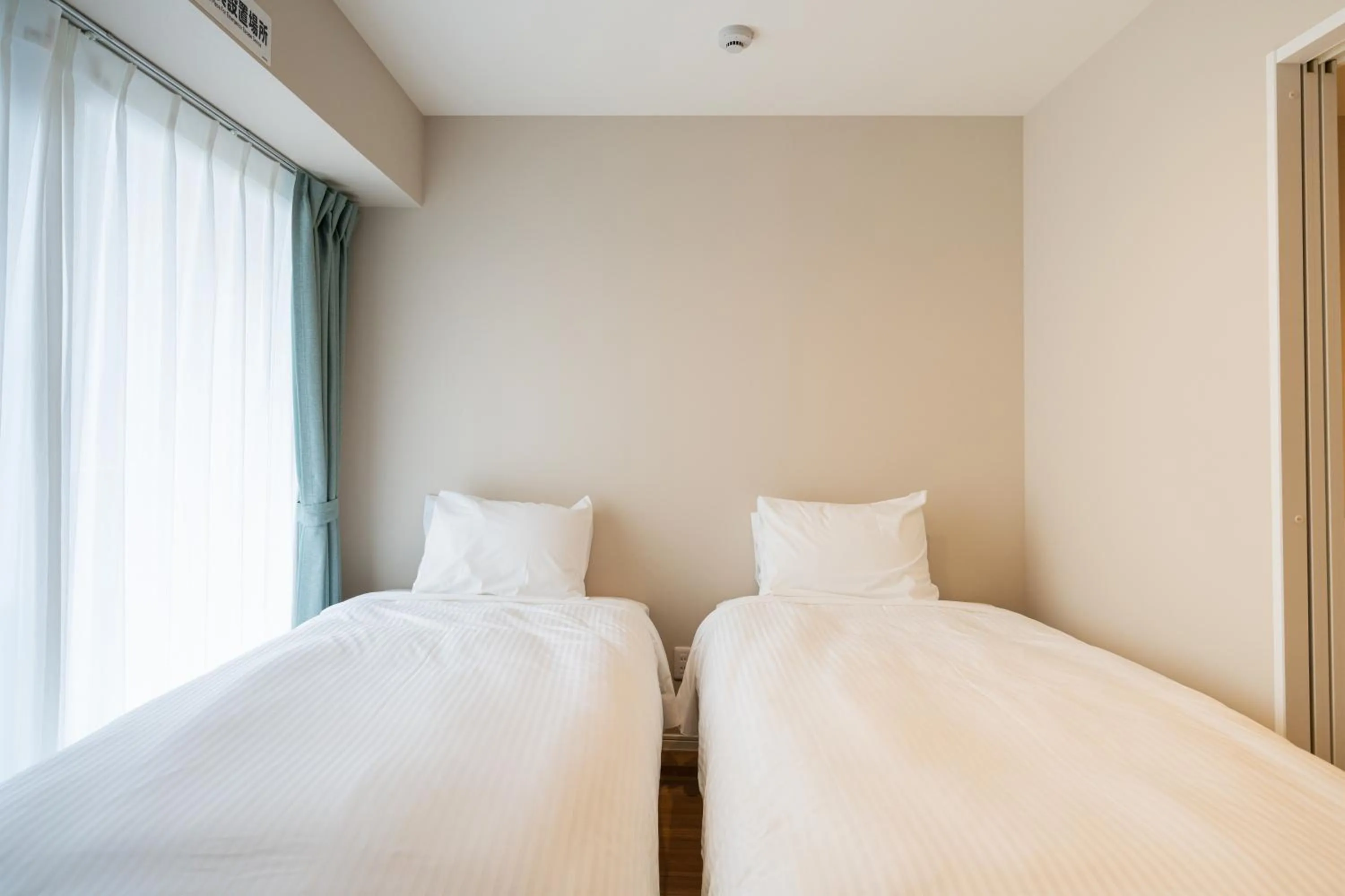 Bed in Tenpoint Hotel OKOU