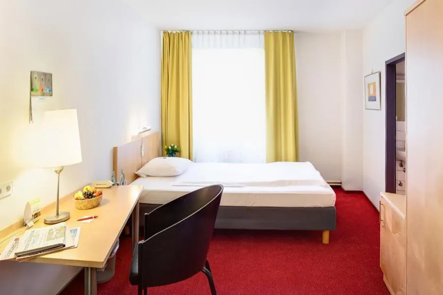 Photo of the whole room, Bed in CVJM Düsseldorf Hotel & Tagung
