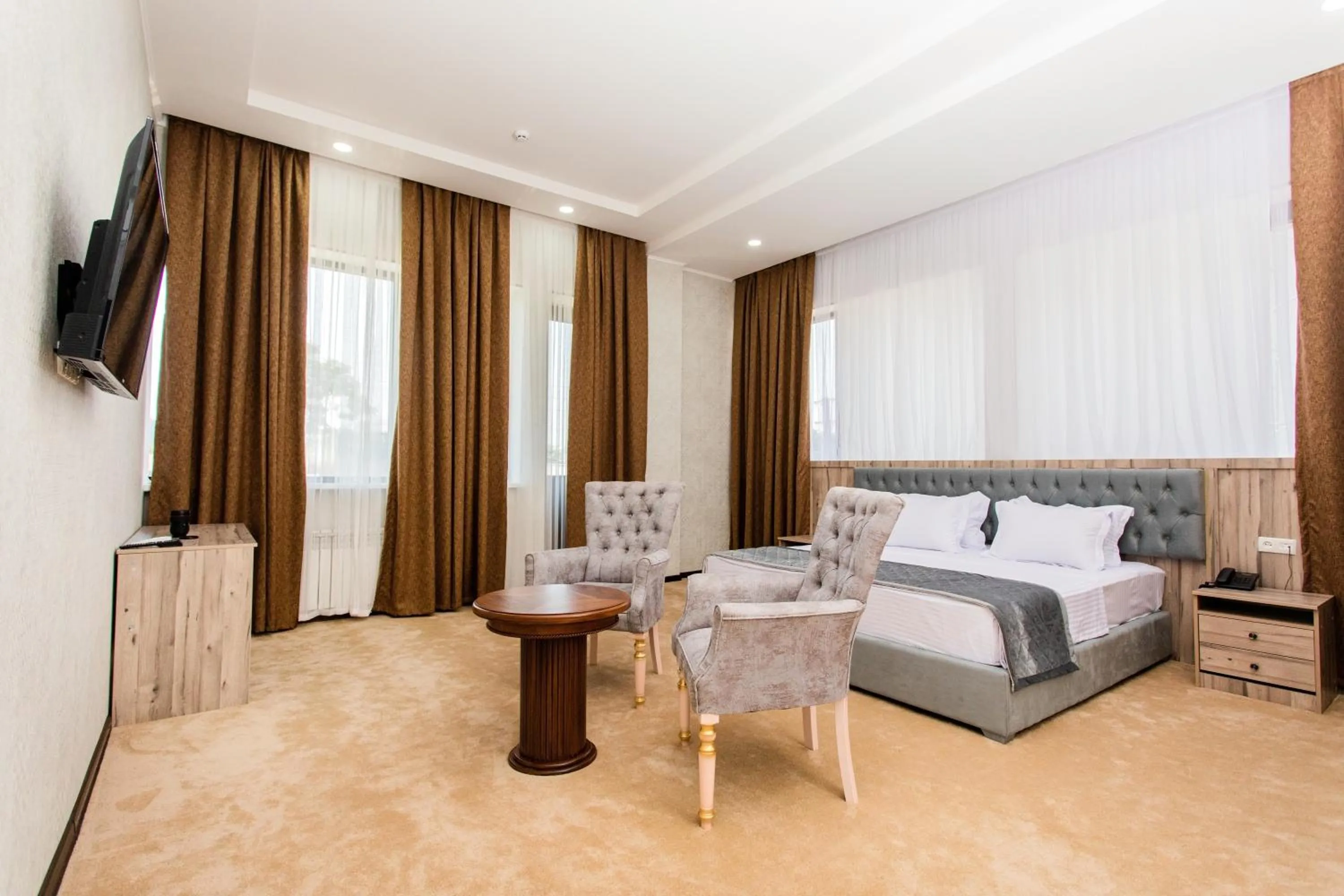 Communal lounge/ TV room, Bed in Gabrielle International Hotel