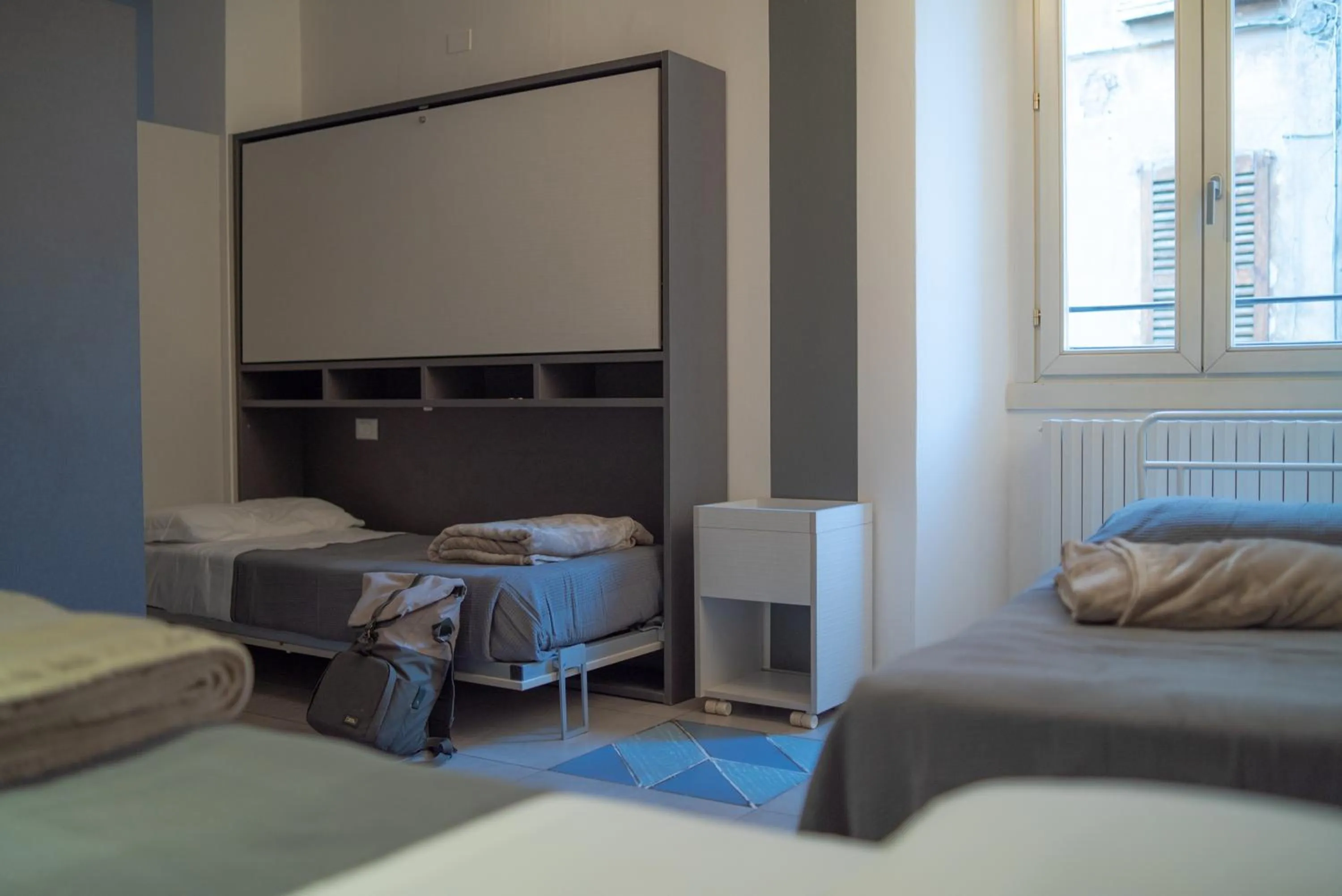 Photo of the whole room in LUOGO COMUNE Ostello