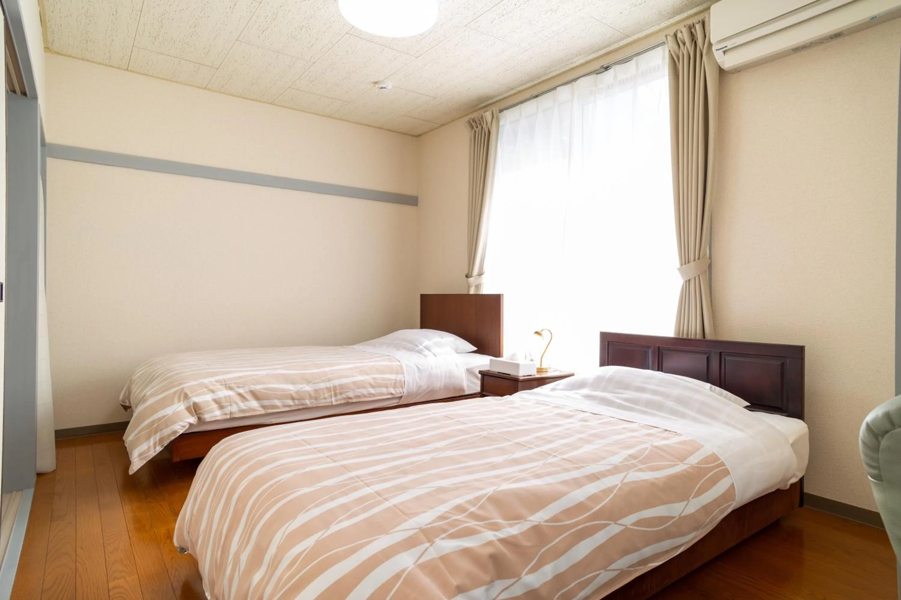 Bed in Enoshima Apartment Hotel
