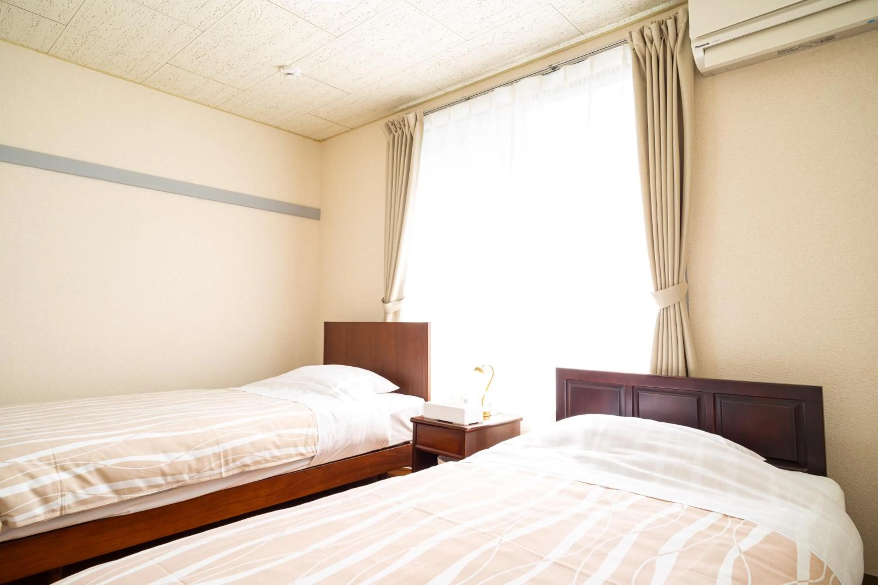 Bed in Enoshima Apartment Hotel