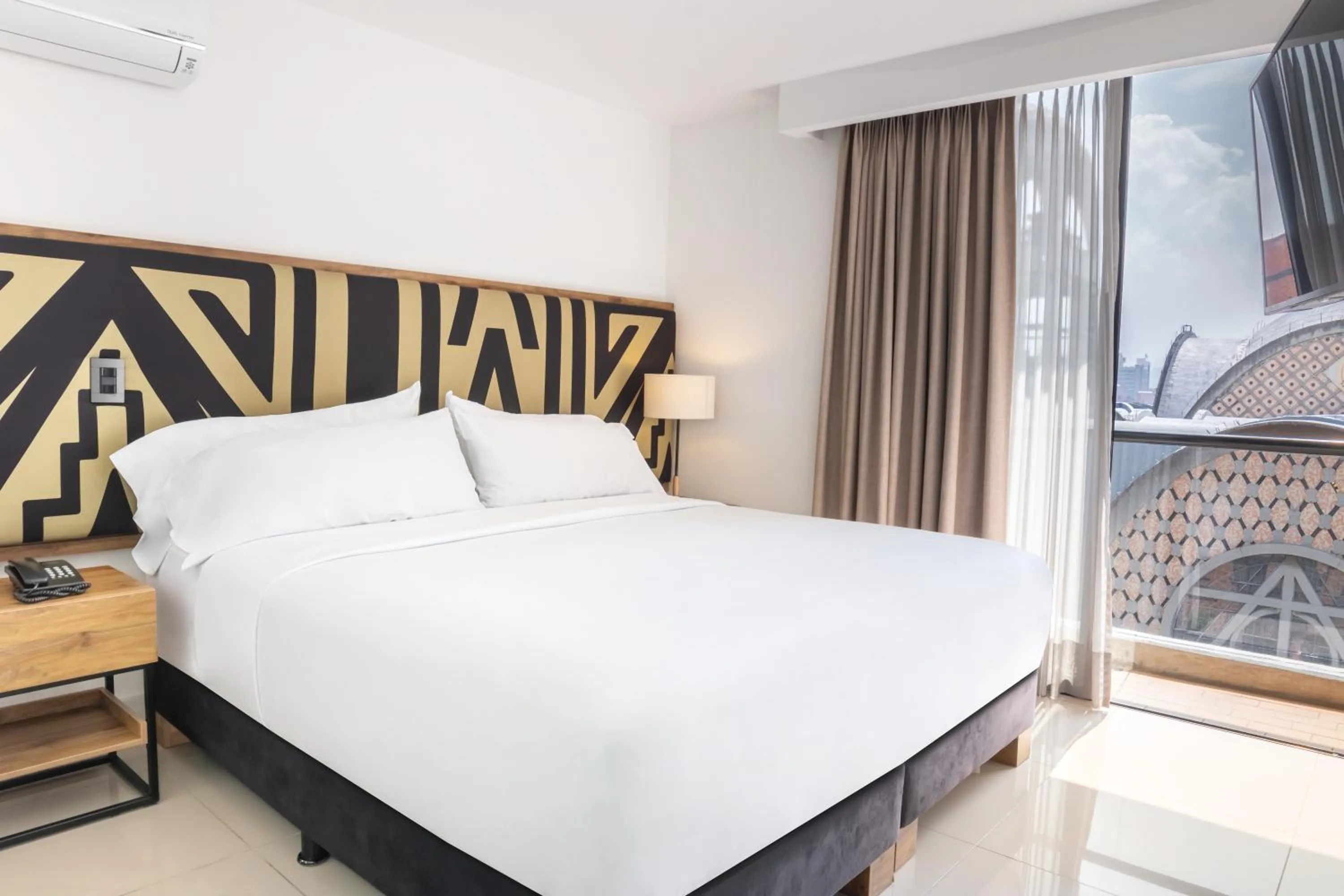 Bed in Origen Local Suites