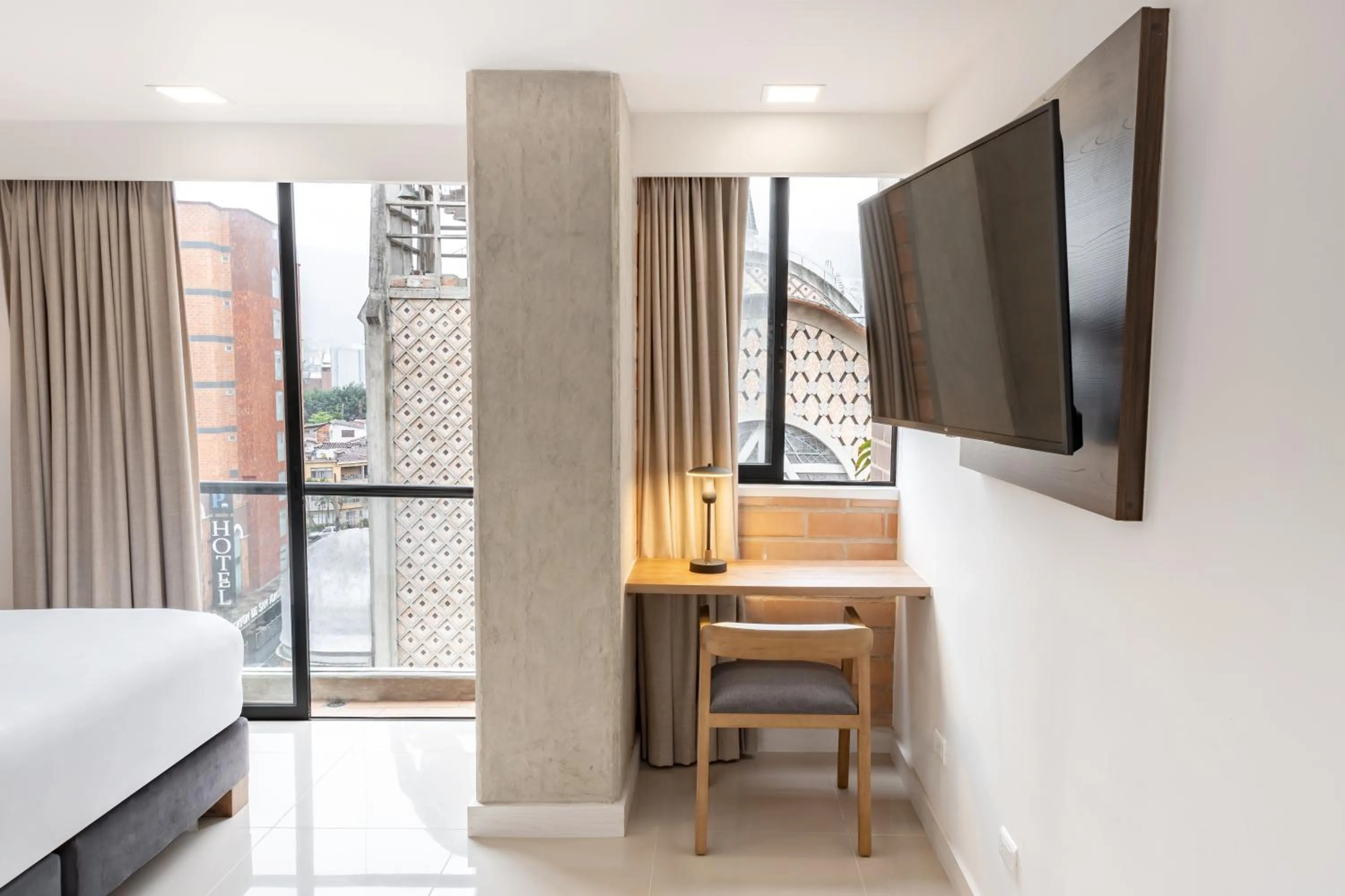 Seating area, Bed in Origen Local Suites