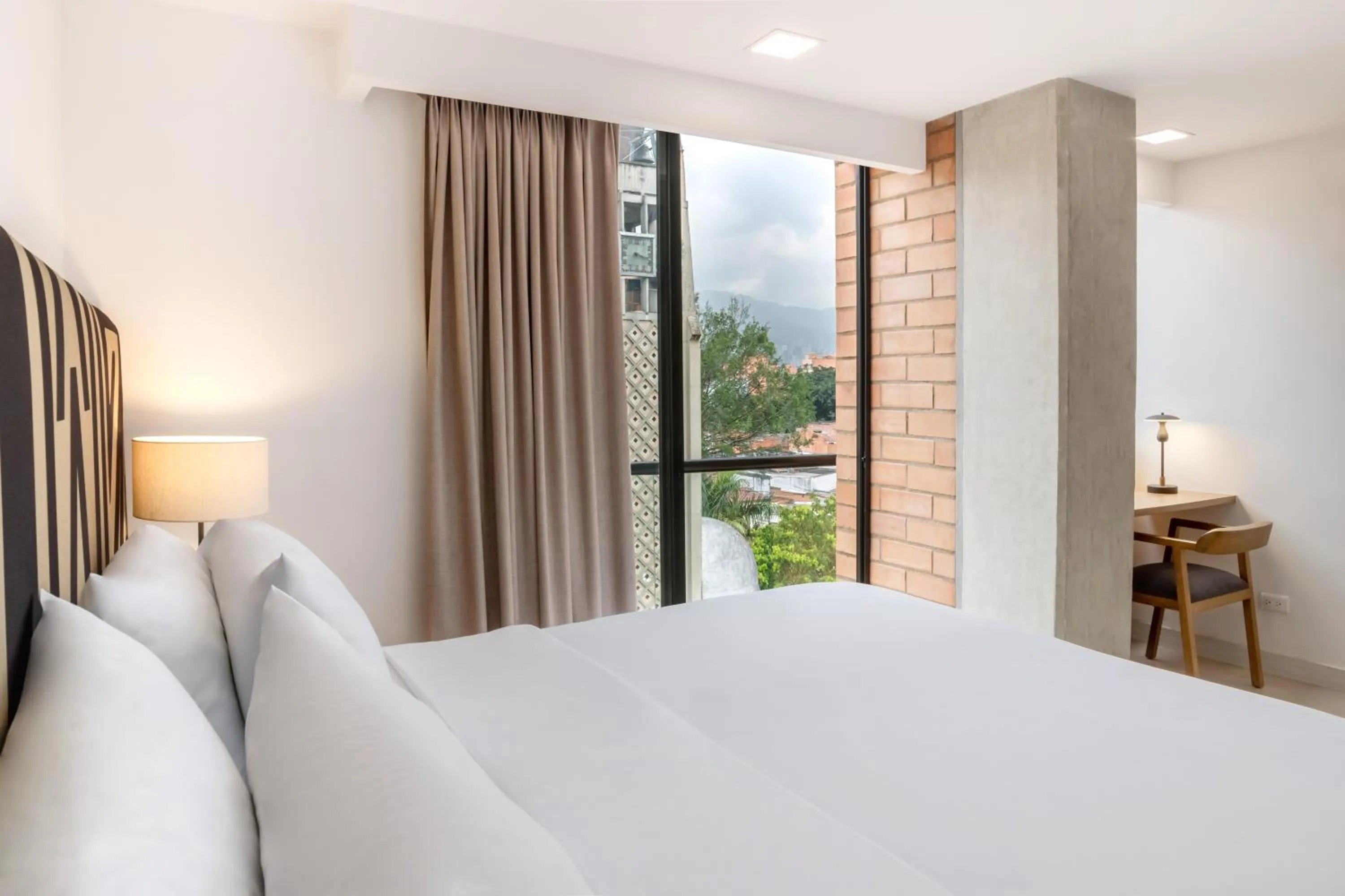 Bed in Origen Local Suites