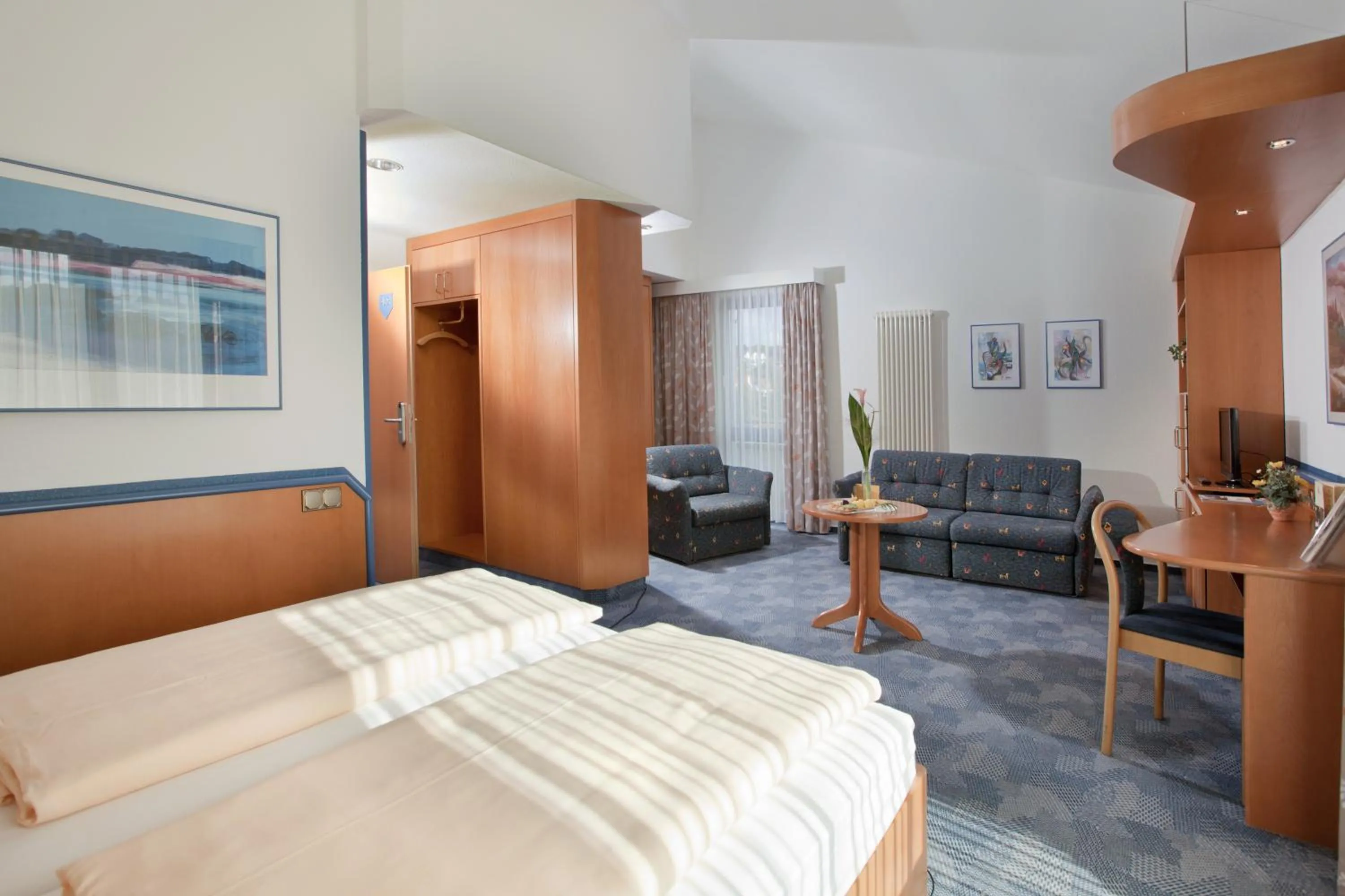 Seating area, Bed in Posthotel Rotenburg