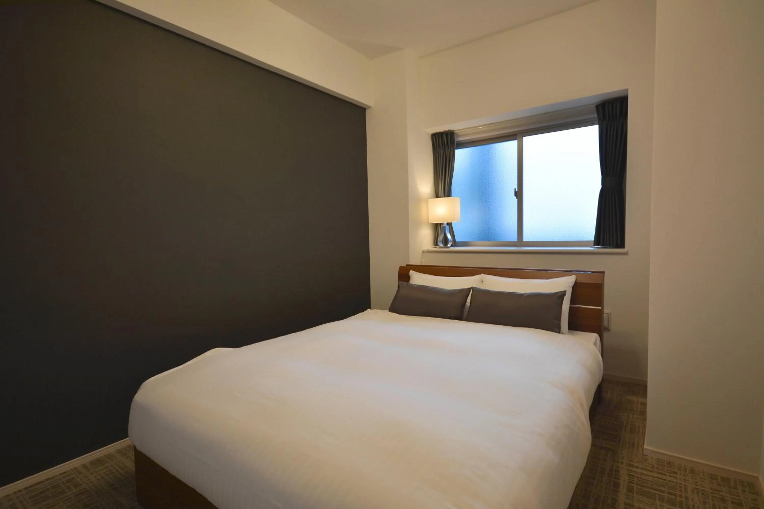 Bed in The Grand Residence Hotel Tenjin