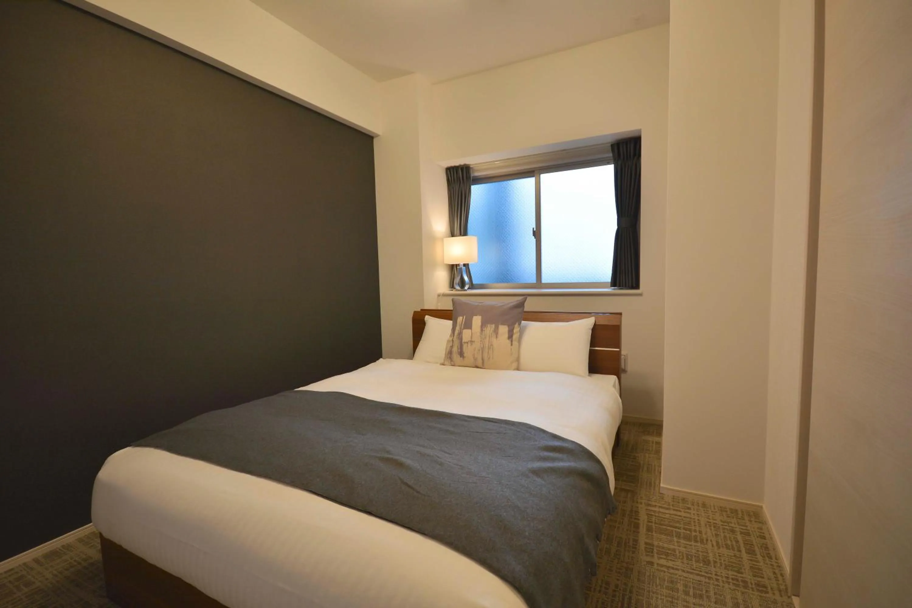 Bed in The Grand Residence Hotel Tenjin