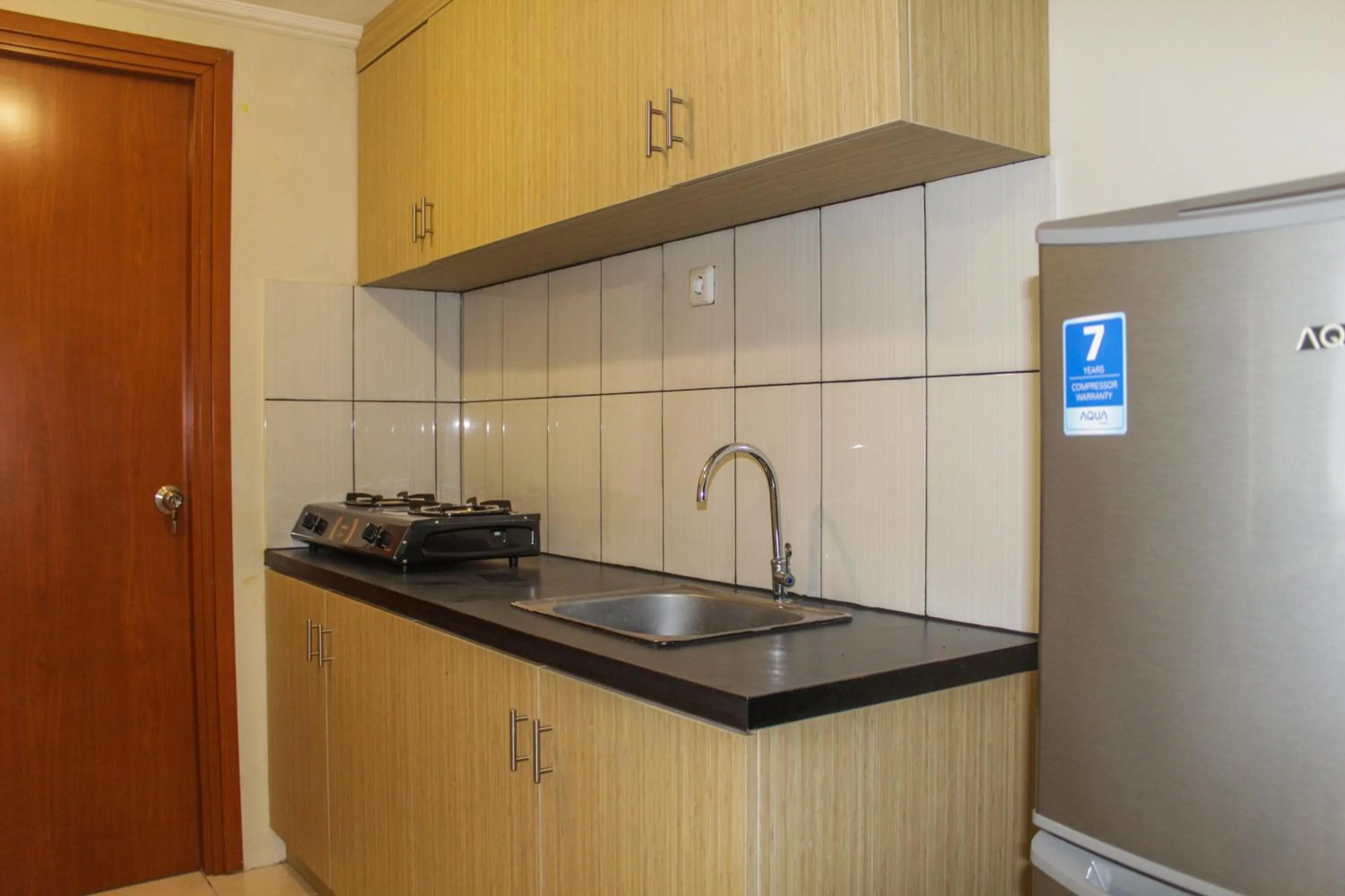 Kitchen or kitchenette in Homey 2BR Apartment at Grand Palace Kemayoran By Travelio
