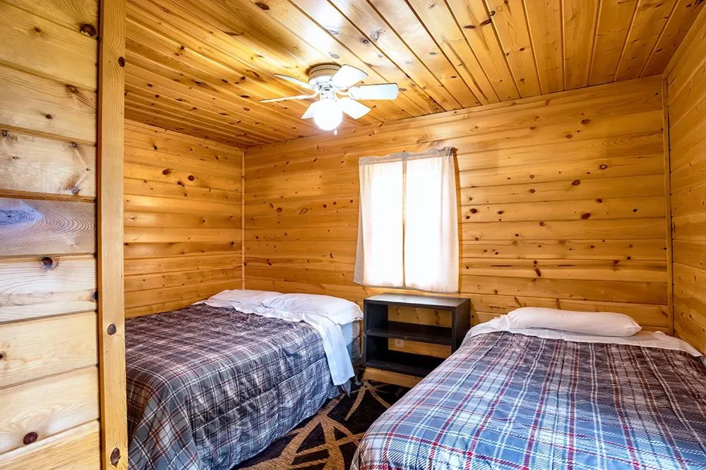 Bed in Big River Escape Riverside Cabins