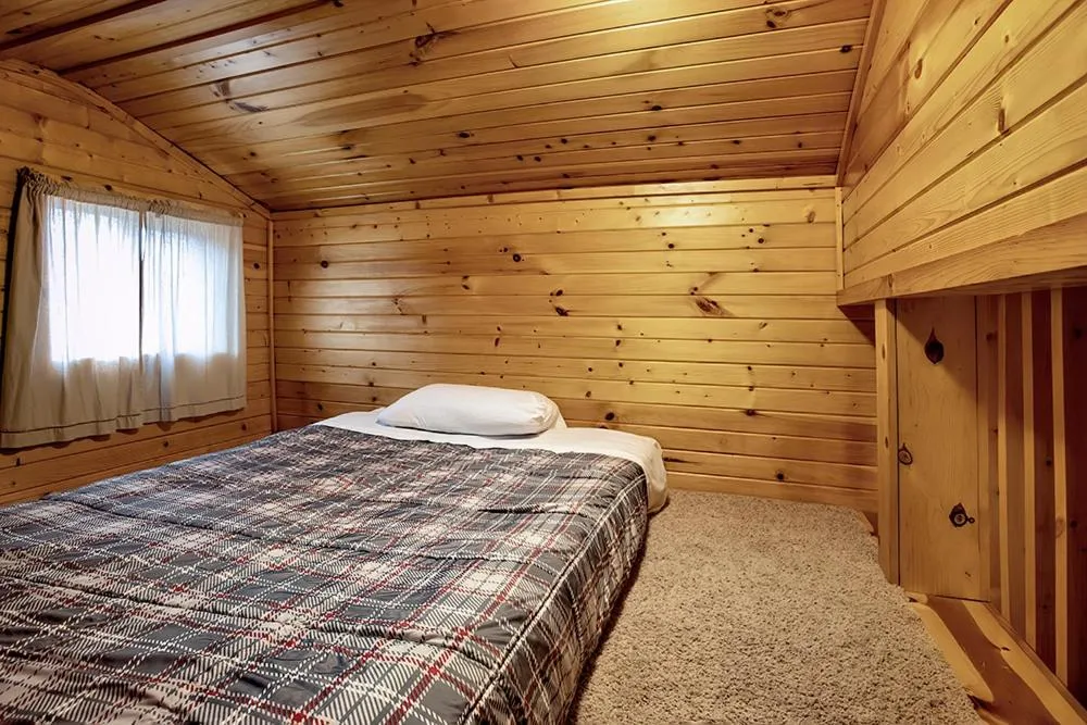 Bed in Big River Escape Riverside Cabins