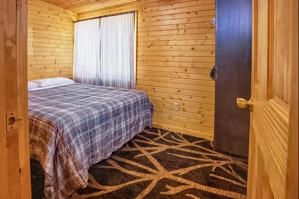 Bed in Big River Escape Riverside Cabins