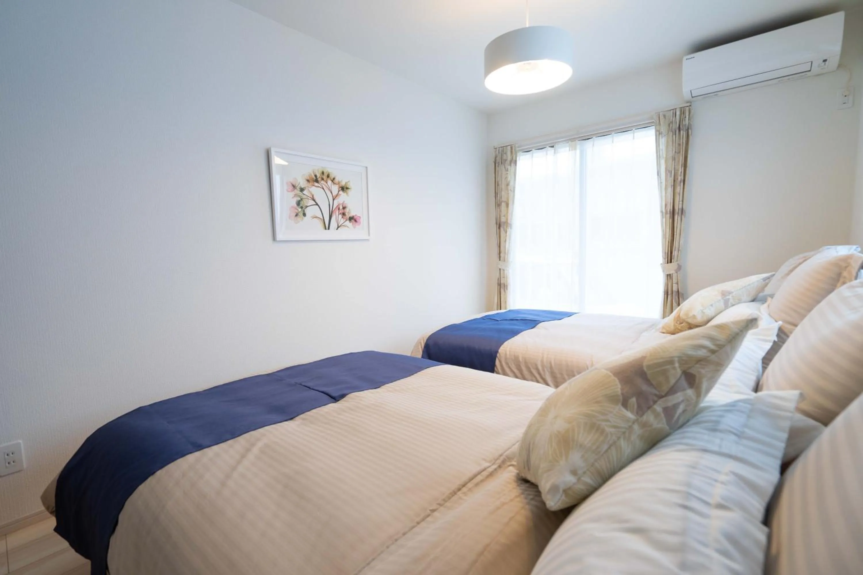 Photo of the whole room, Bed in OKINAWA BEACH HOUSE Golden Drop S