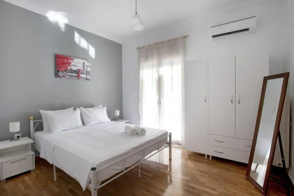 Bed in Kolonos, a renovated apartment