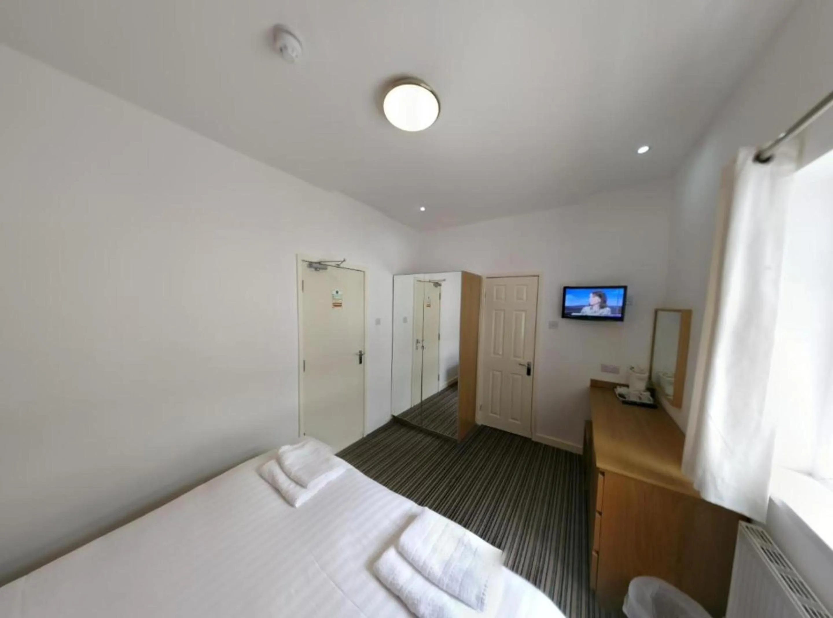 Bed in OYO Wave Crest Hotel