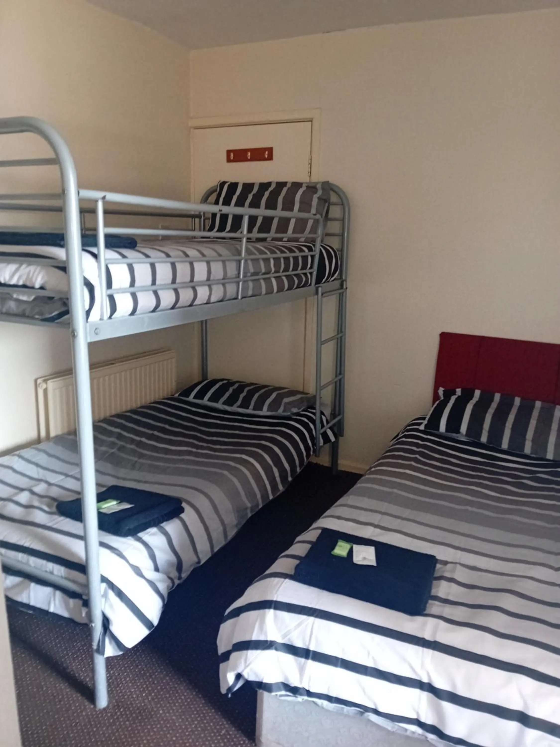 Bed in MyRoomz New Discovery Hotel