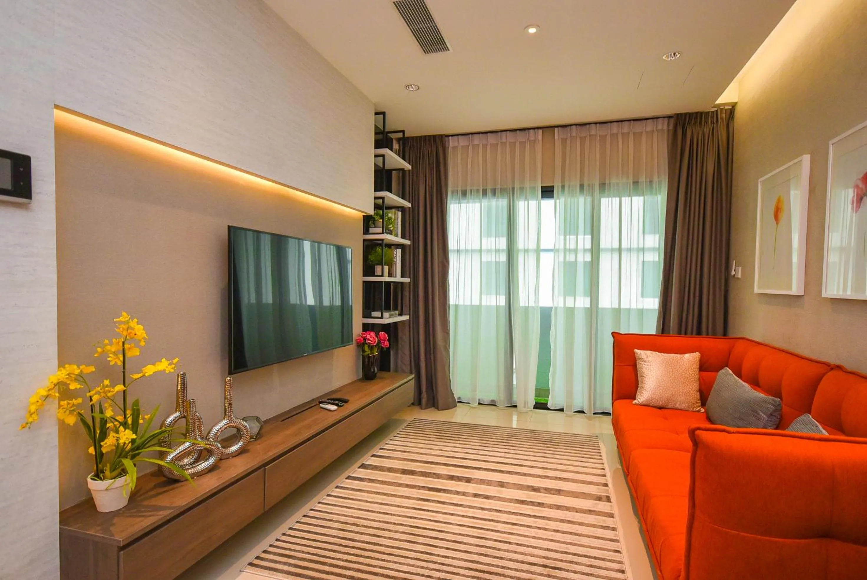 Living room in Suasana Residence by Nest Home