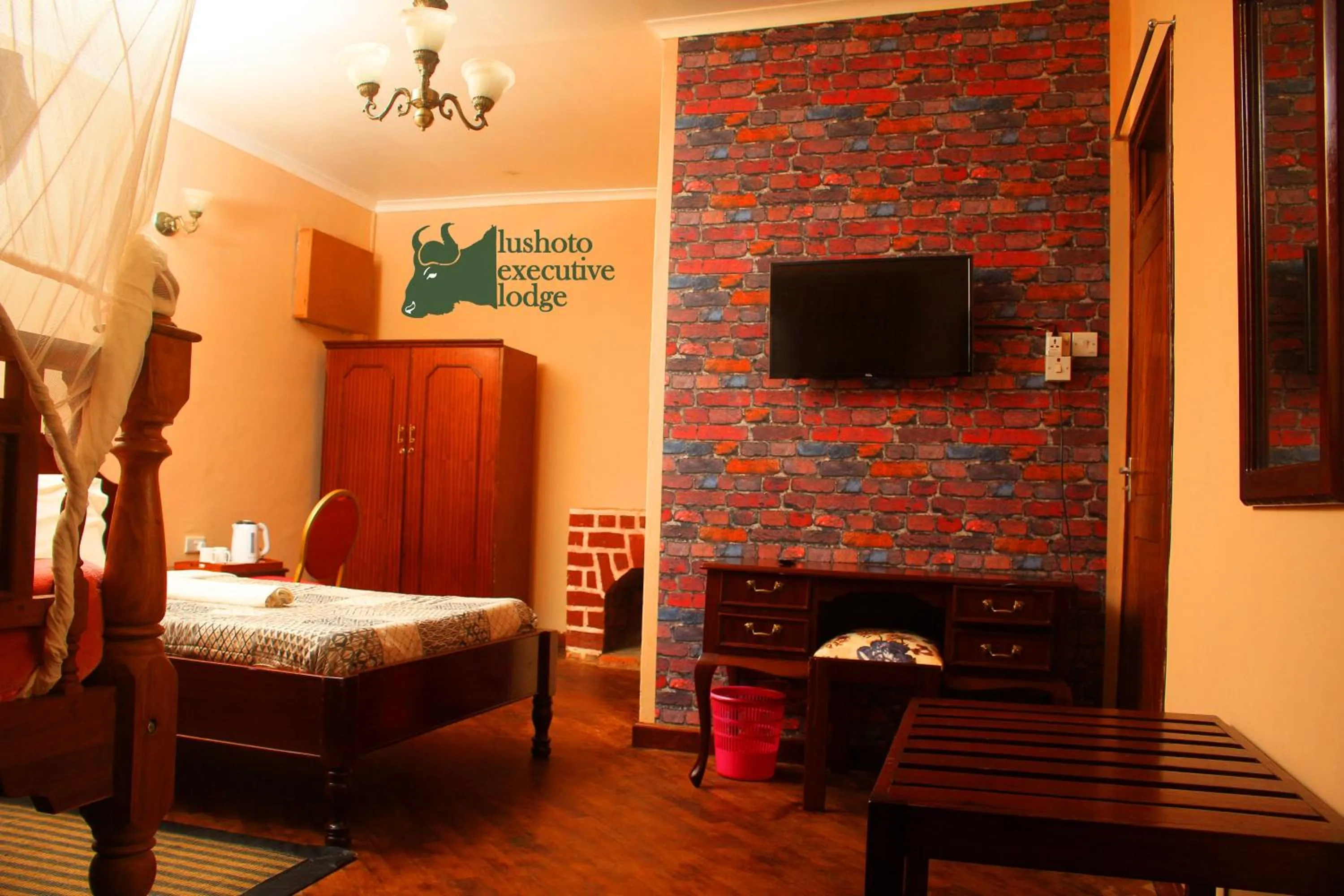 Communal lounge/ TV room, Bed in LUSHOTO EXECUTIVE LODGE