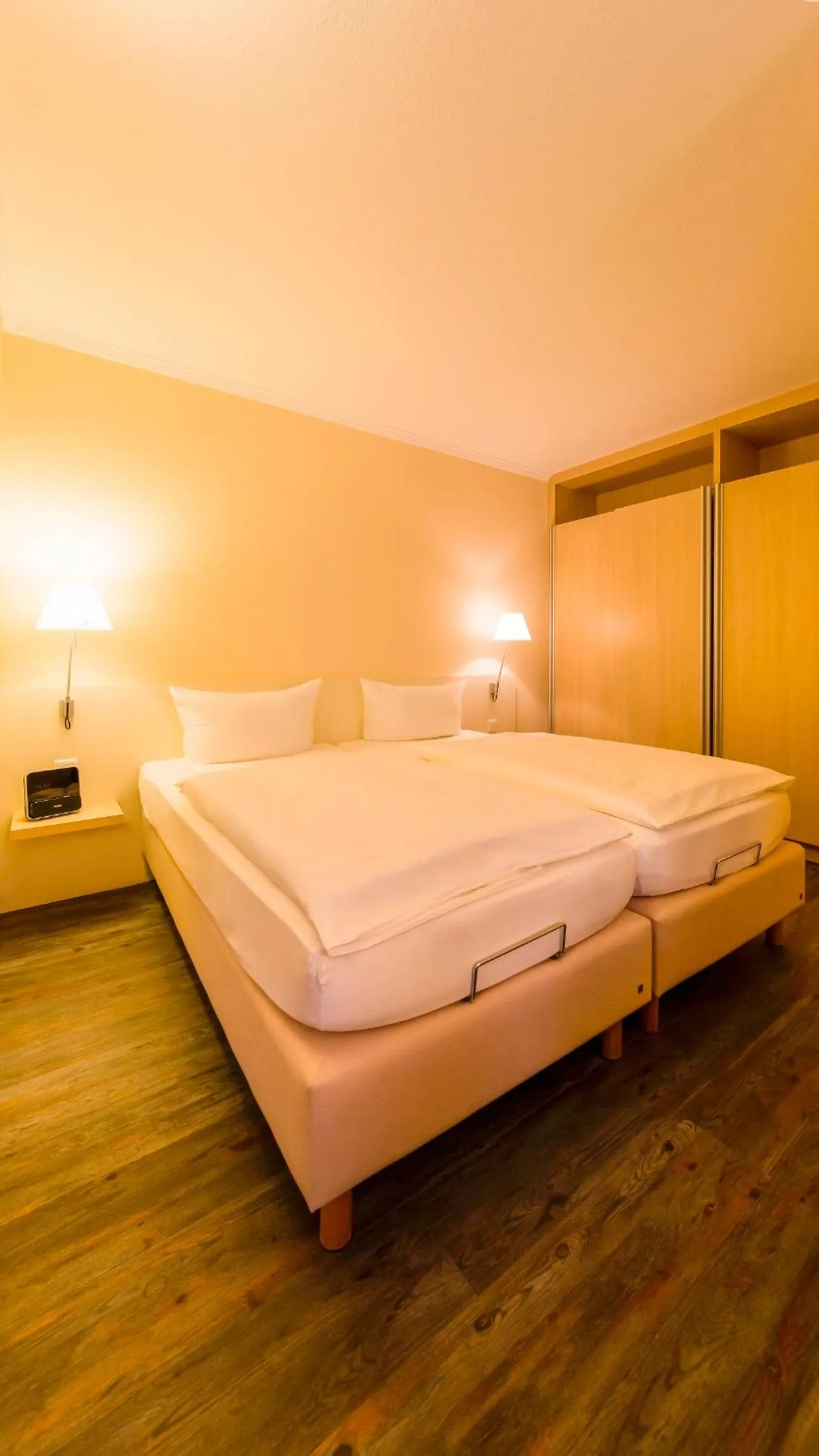 Photo of the whole room, Bed in Michels Thalasso Hotel Nordseehaus