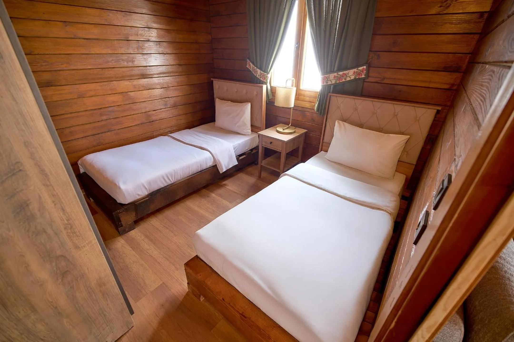 Bed in Flora Handüzü Resort & Wellness Bungalow Hotel