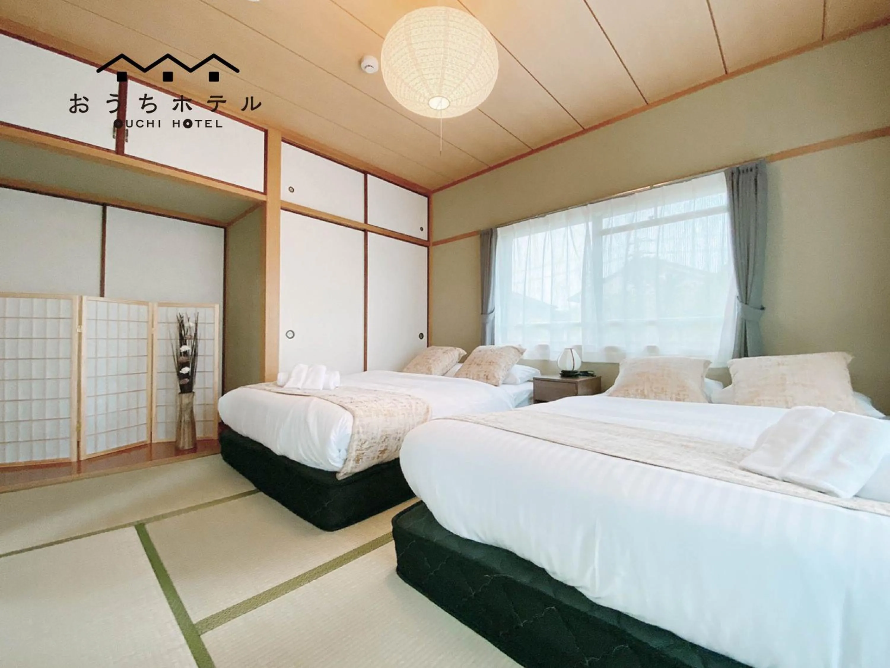 Bed in OUCHI HOTEL Itsukaichi