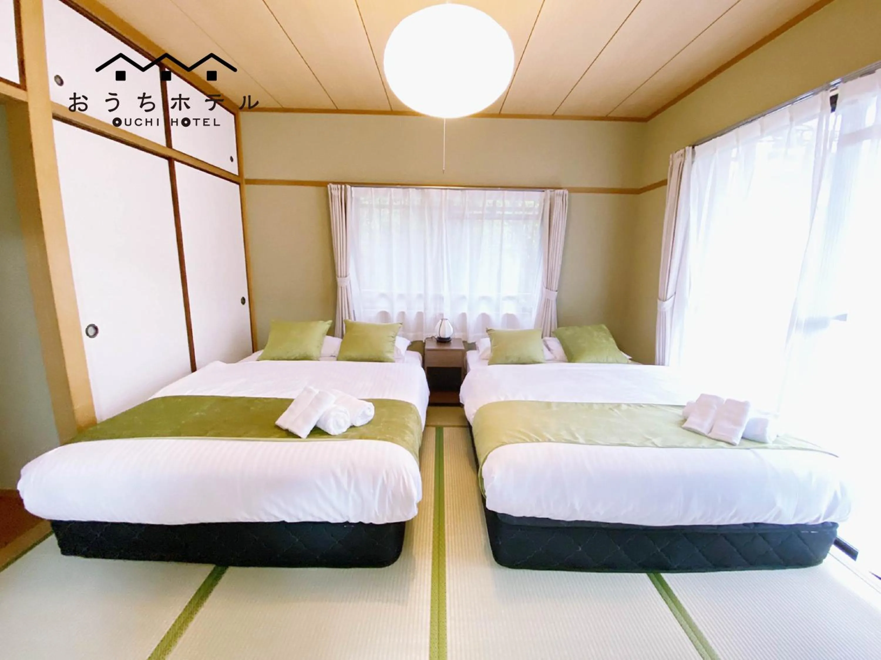 Bed in OUCHI HOTEL Itsukaichi