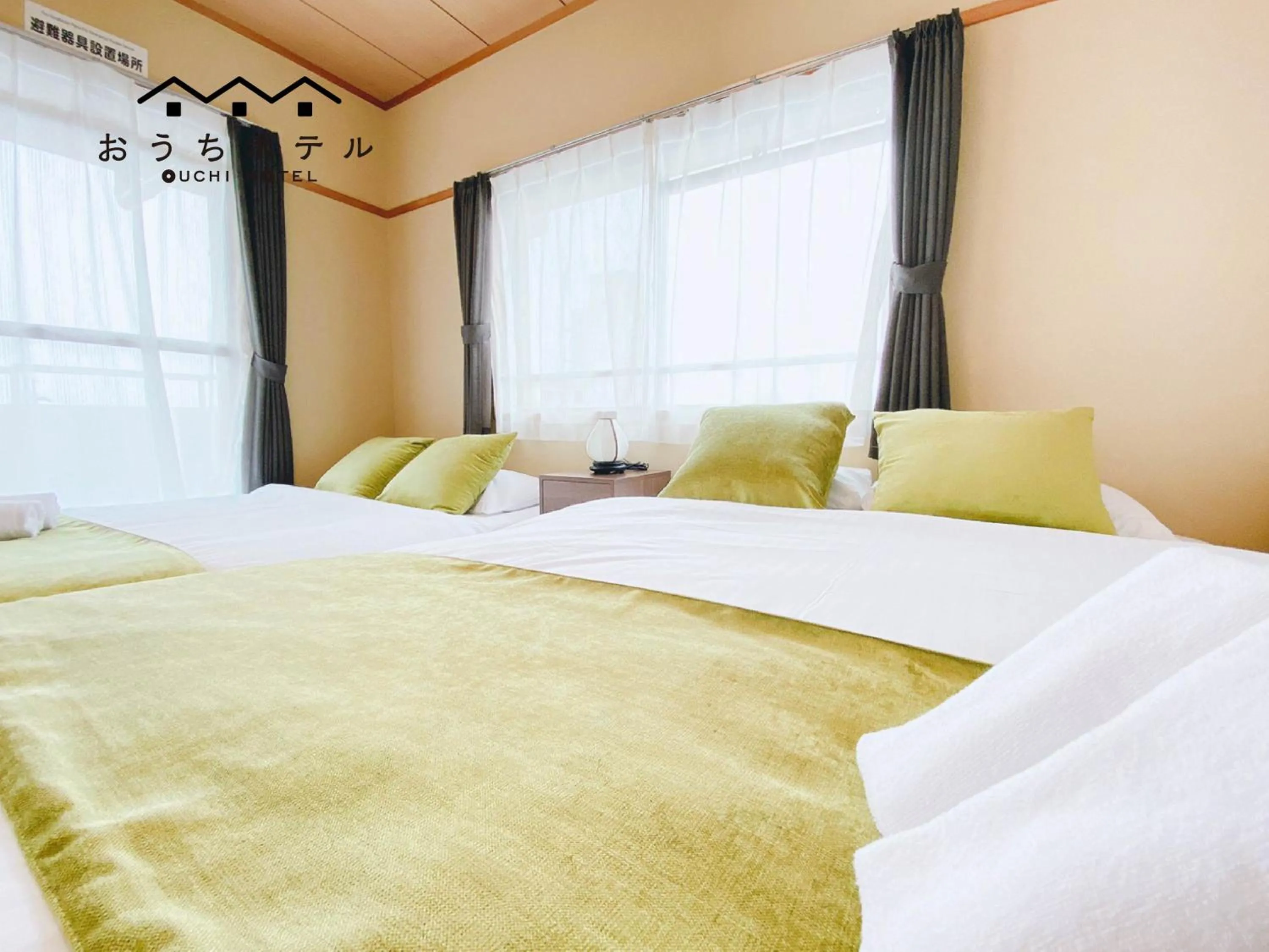 Bed in OUCHI HOTEL Itsukaichi