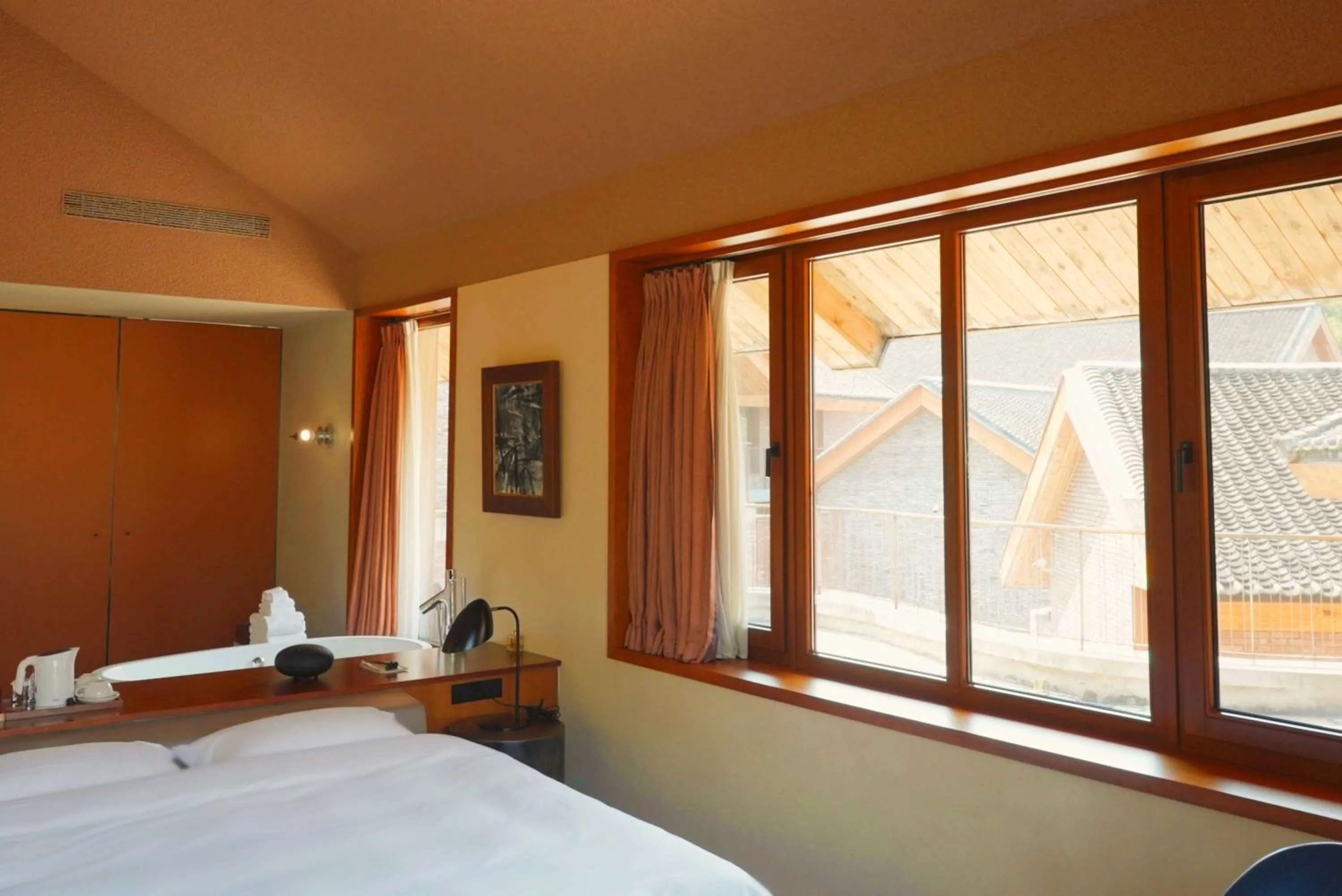 Bed in Sansa Village Boutique Hotel at Mutianyu Great Wall Adjoin to Mutianyu Great Wall - Room with the View of Great Wall - Jacuzzi with the View of Great Wall - Vehicle Shuttle Service - International Catering - SPA& Nail Beauty Facilities