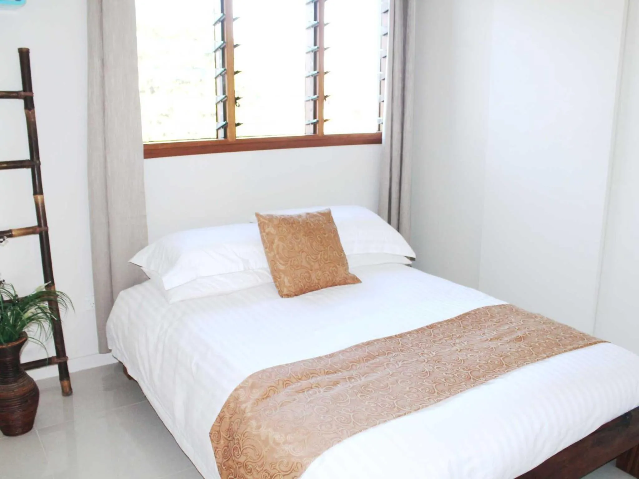 Bed in Vanuatu Beachfront Apartments