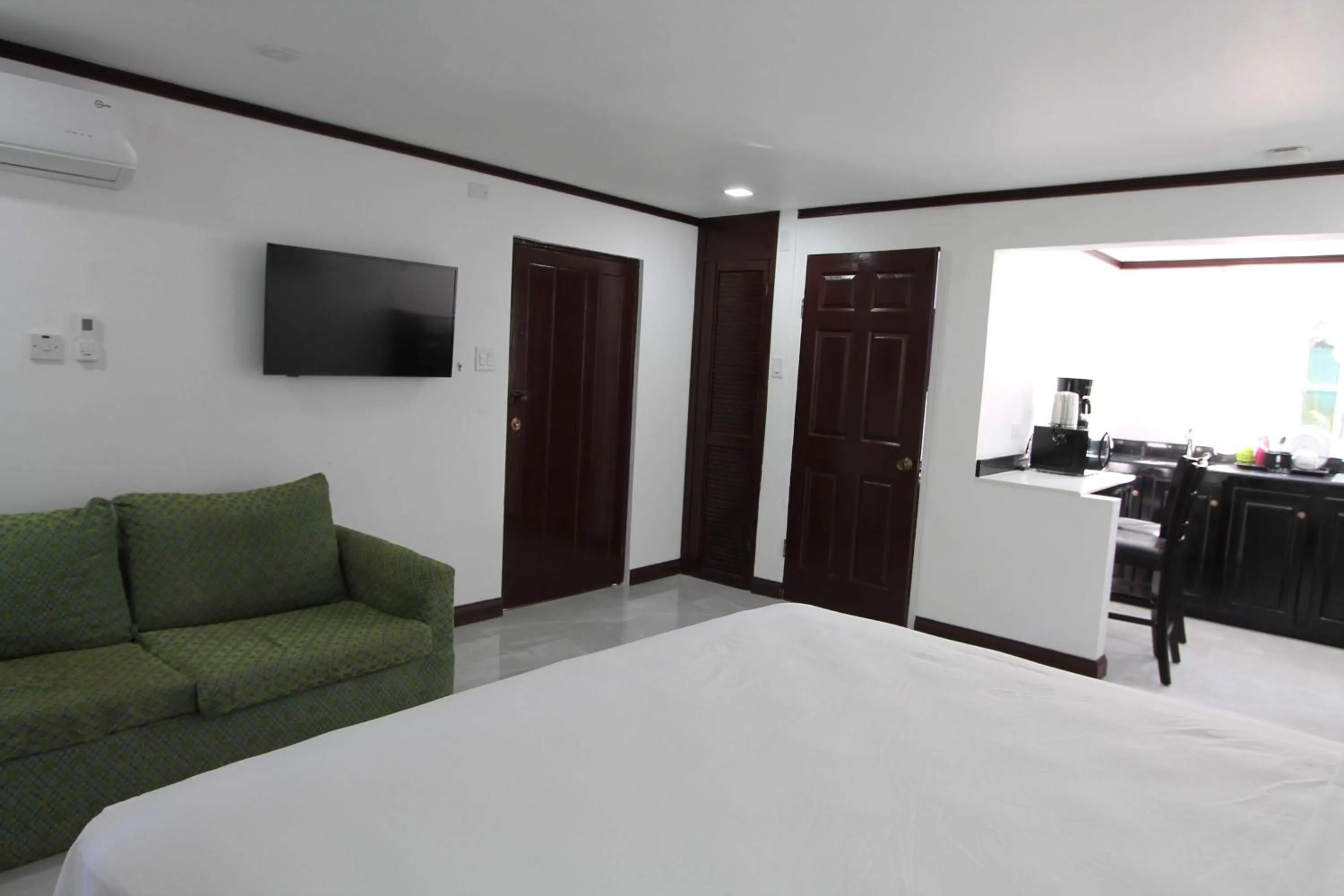 Photo of the whole room, Bed in Sand and Blue Seas