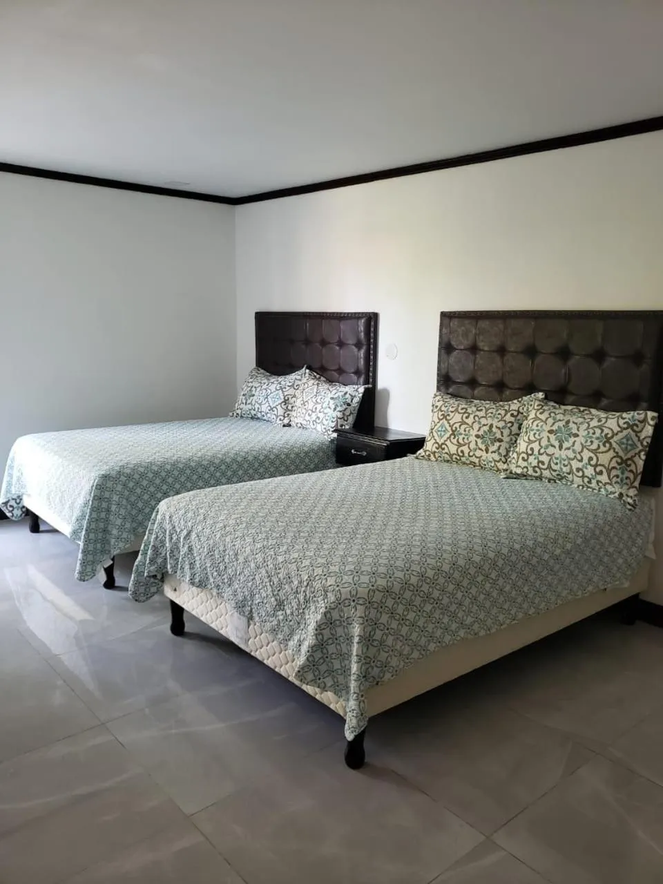 Bed in Sand and Blue Seas