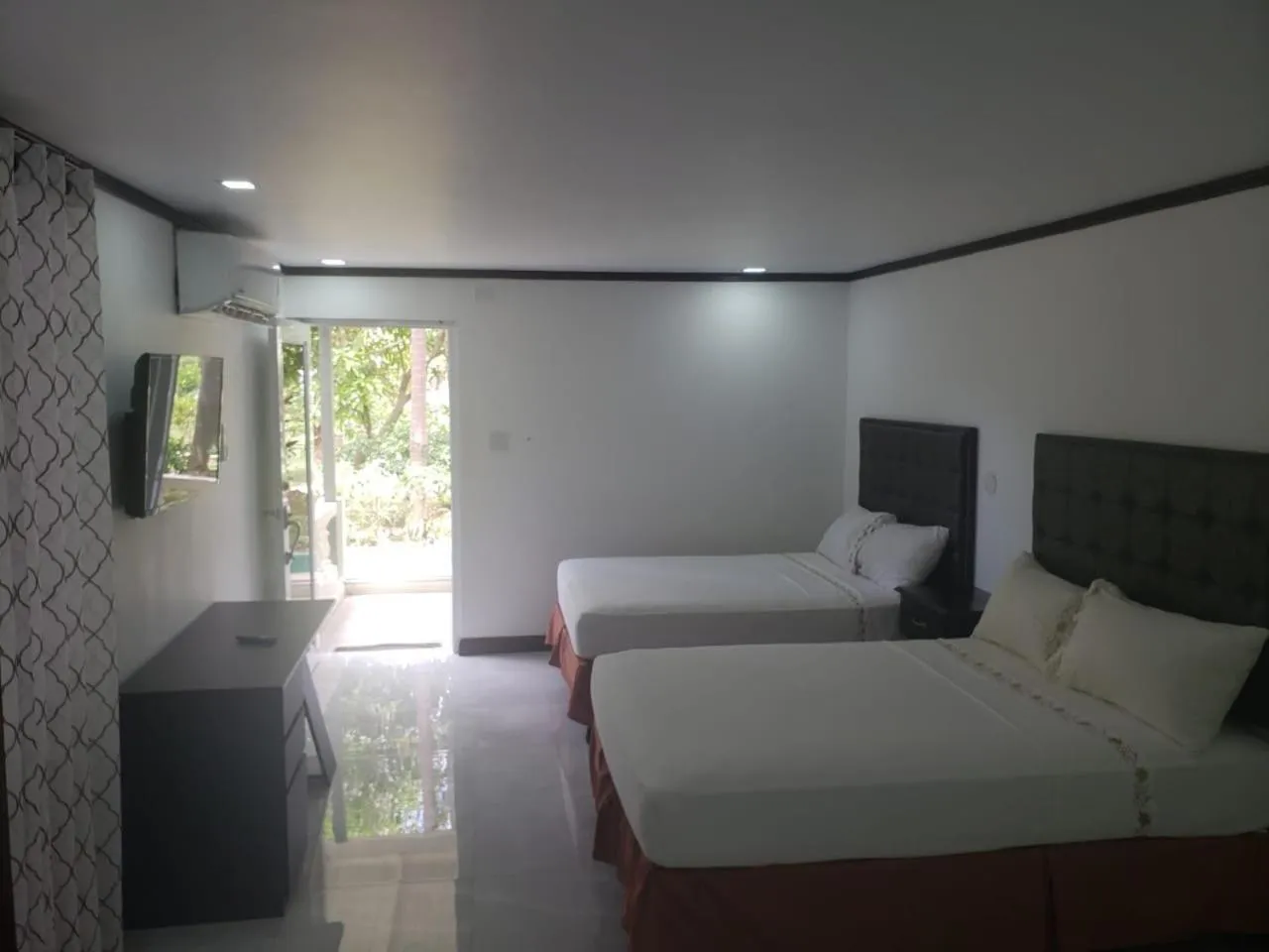 Photo of the whole room, Bed in Sand and Blue Seas