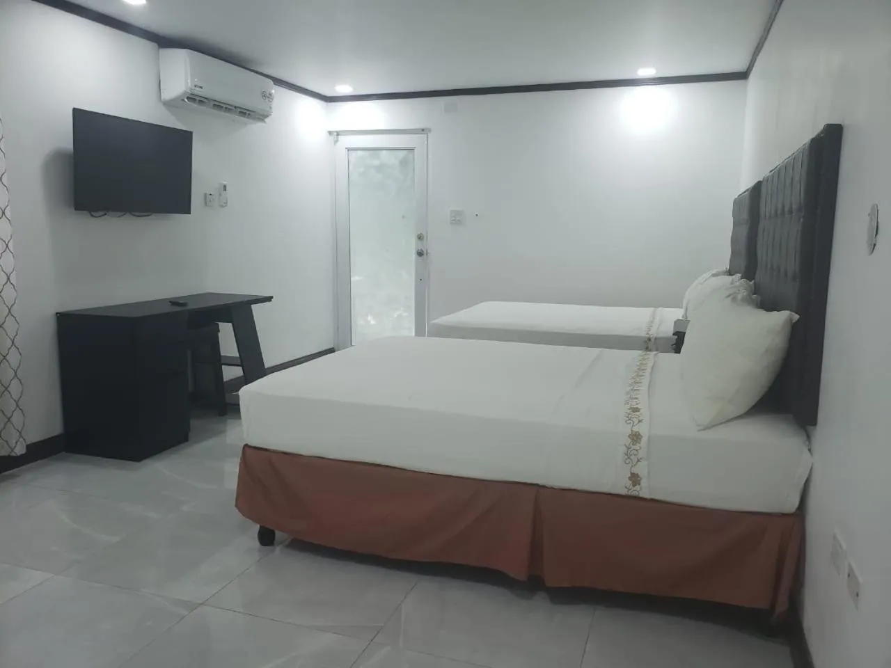 Photo of the whole room, Bed in Sand and Blue Seas