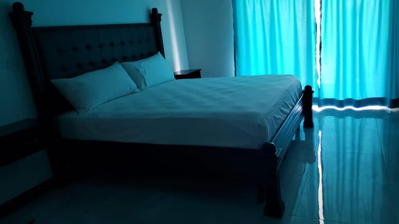 Bed in Sand and Blue Seas