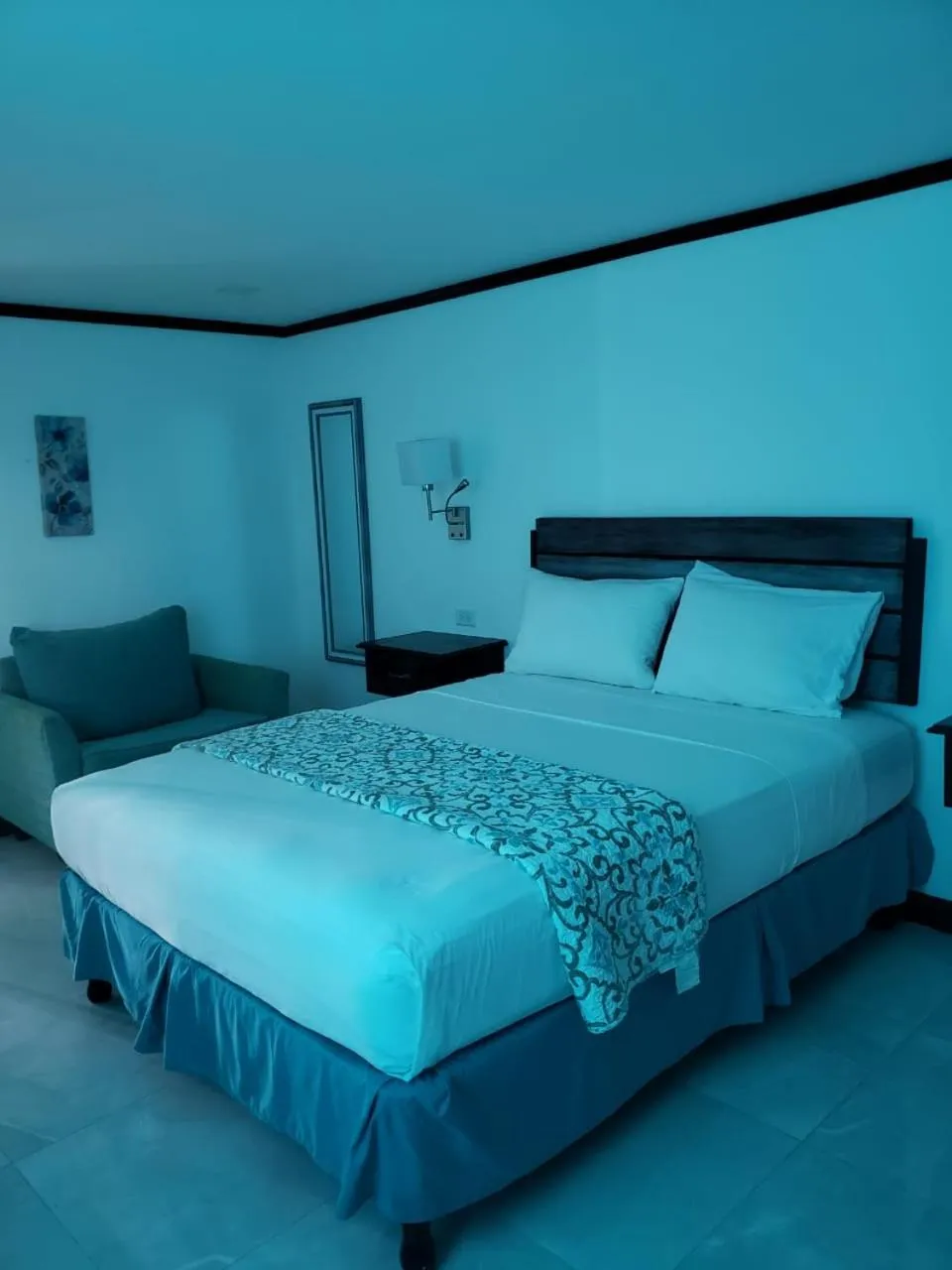 Bed in Sand and Blue Seas