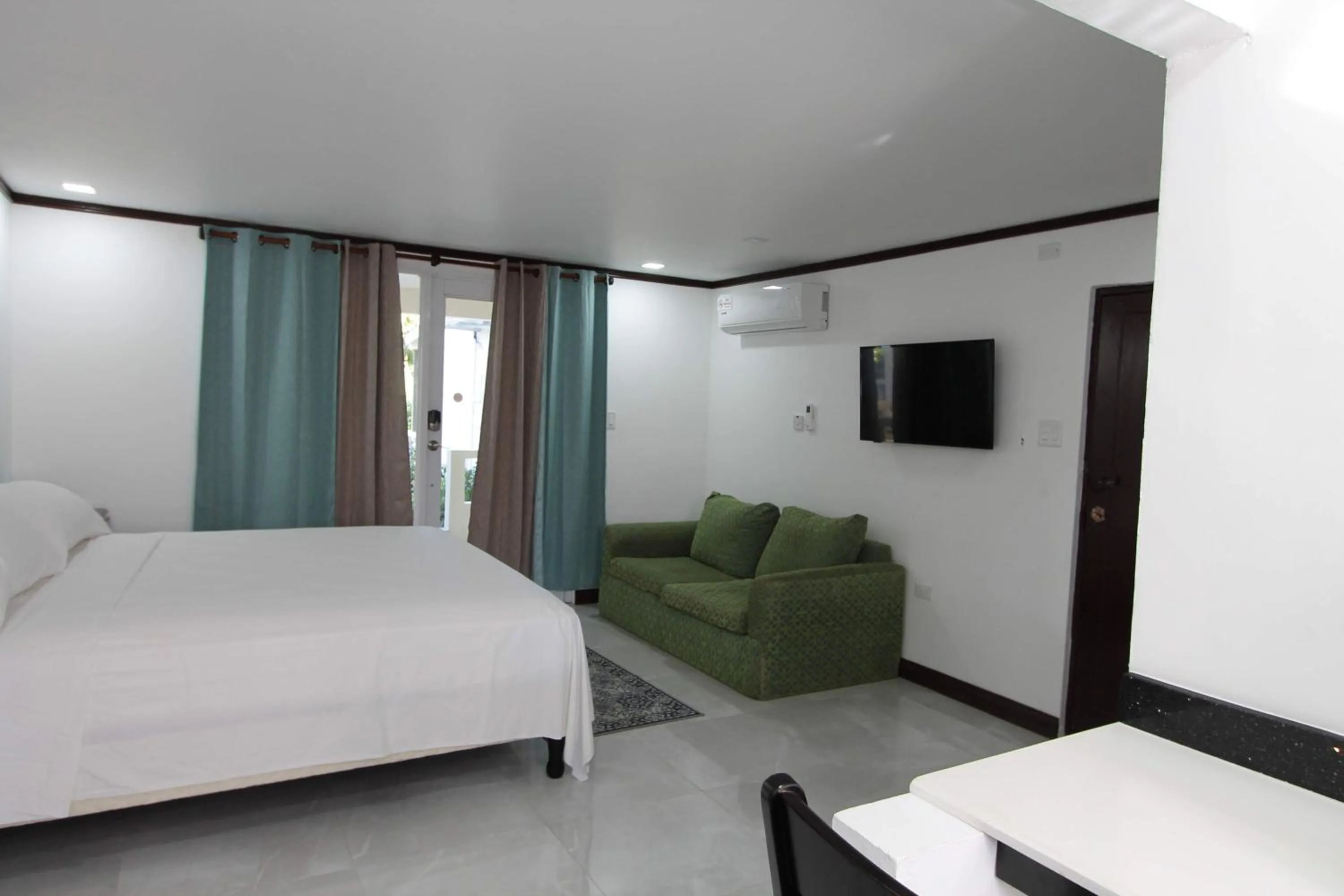 Photo of the whole room, Bed in Sand and Blue Seas