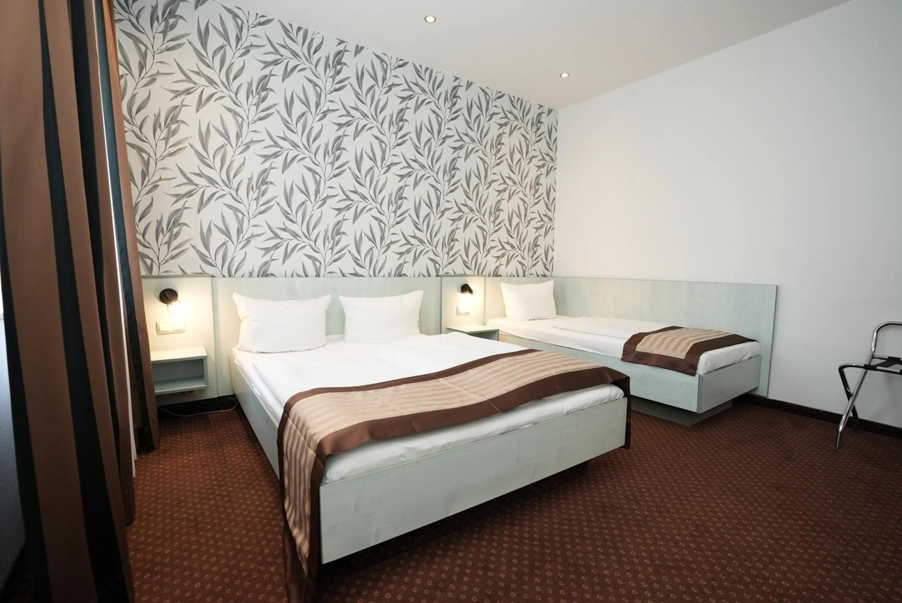 Bed in Hotel Attaché an der Messe