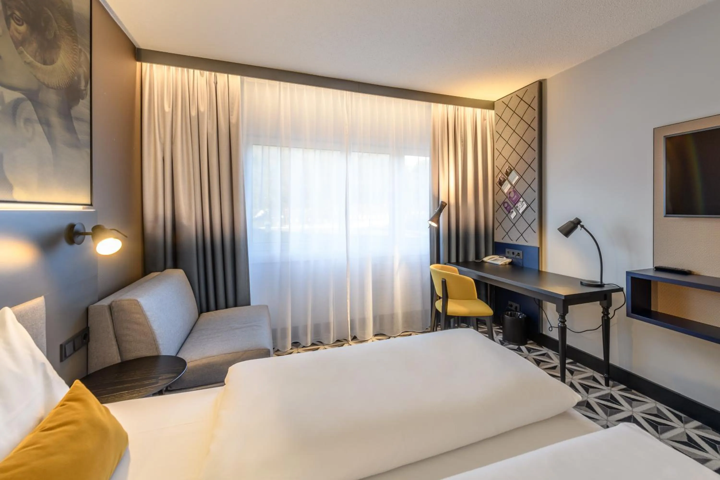 Photo of the whole room, Bed in Mercure Hotel Freiburg am Münster