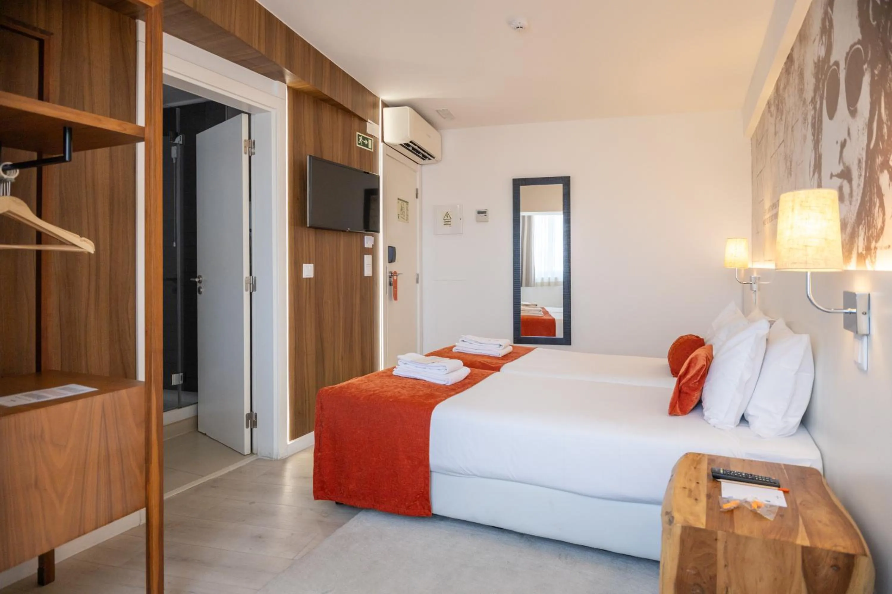 Bed in The ICONS Lisbon Hotel