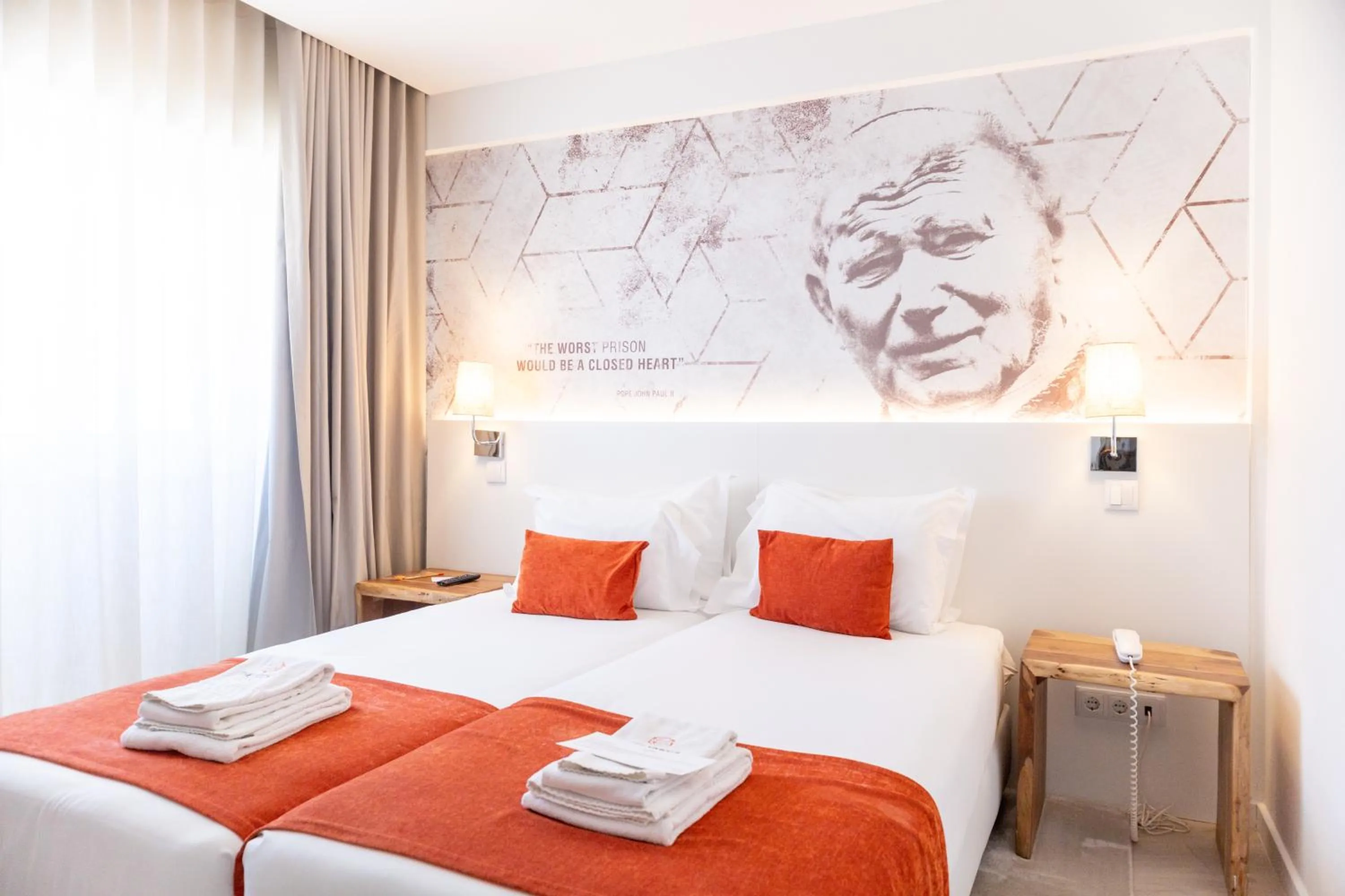 Bed in The ICONS Lisbon Hotel