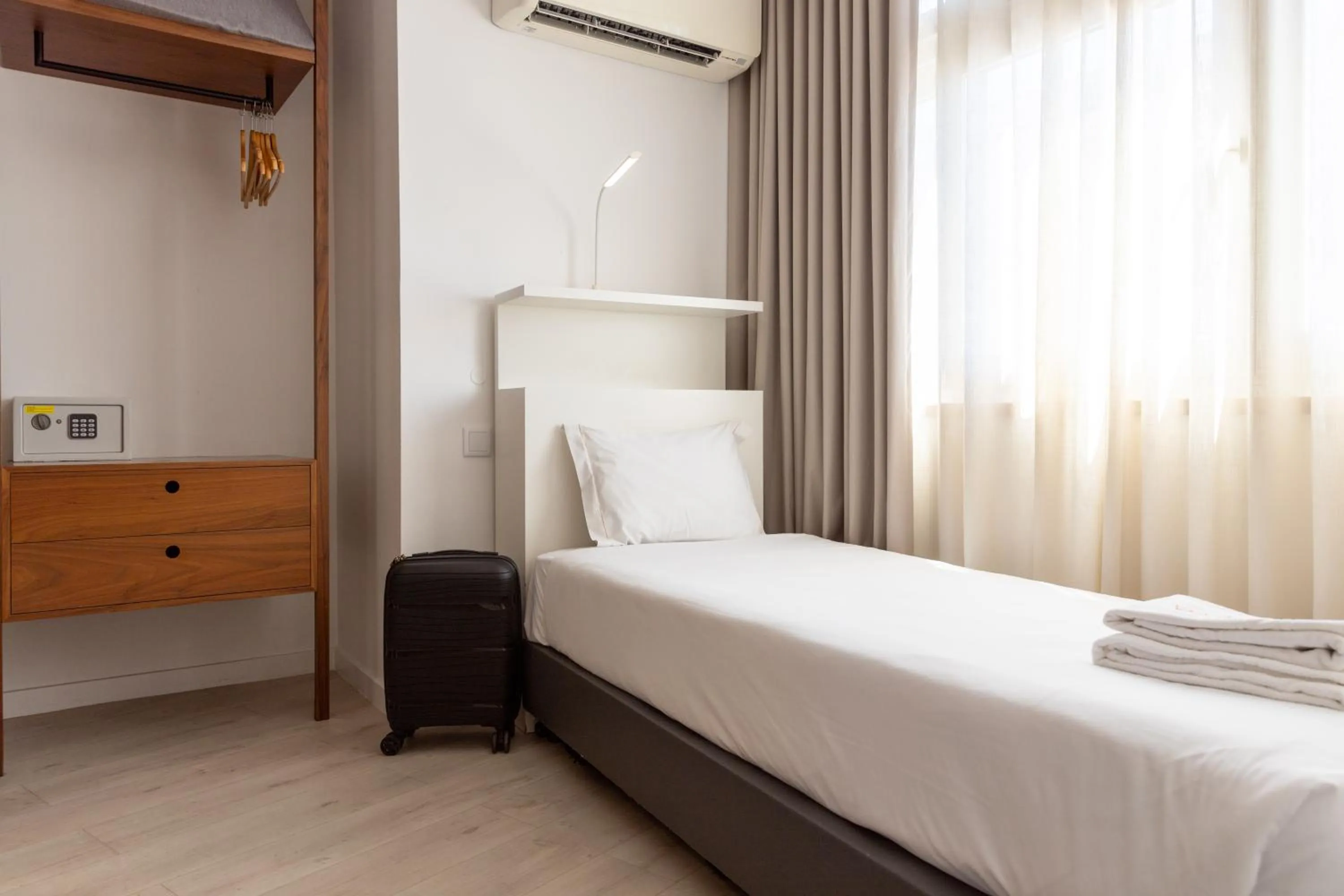 Bed in The ICONS Lisbon Hotel