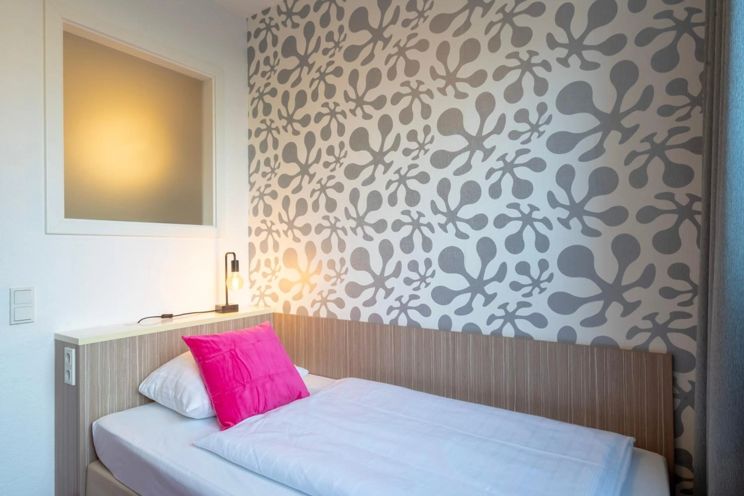 Bed in Hotel Madeleine Biohotel