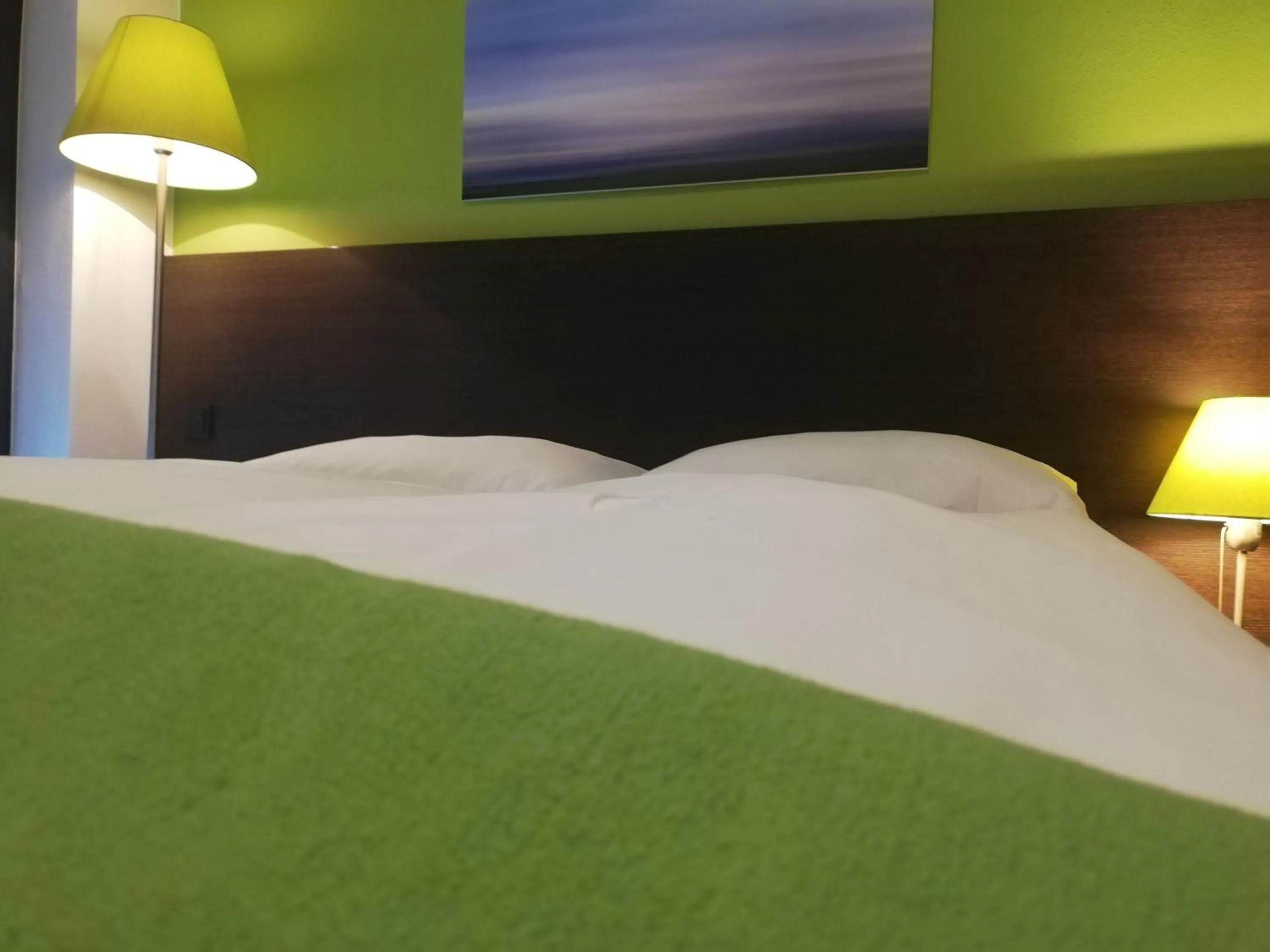 Bed in KH Hotel mit Restaurant